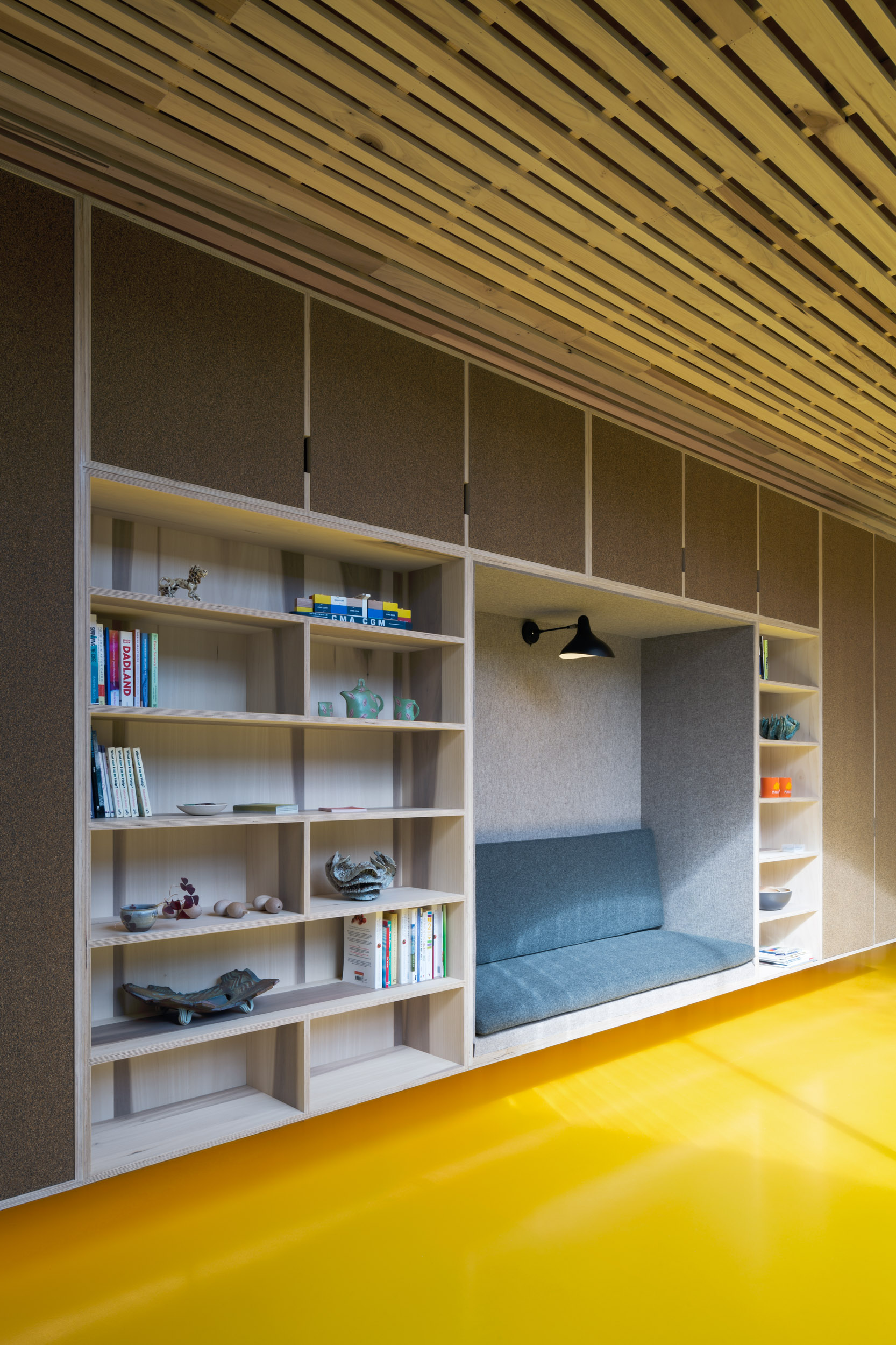 Unique Integrated Seating Arrangement Within Plywood Bookcase and Shelving Unit