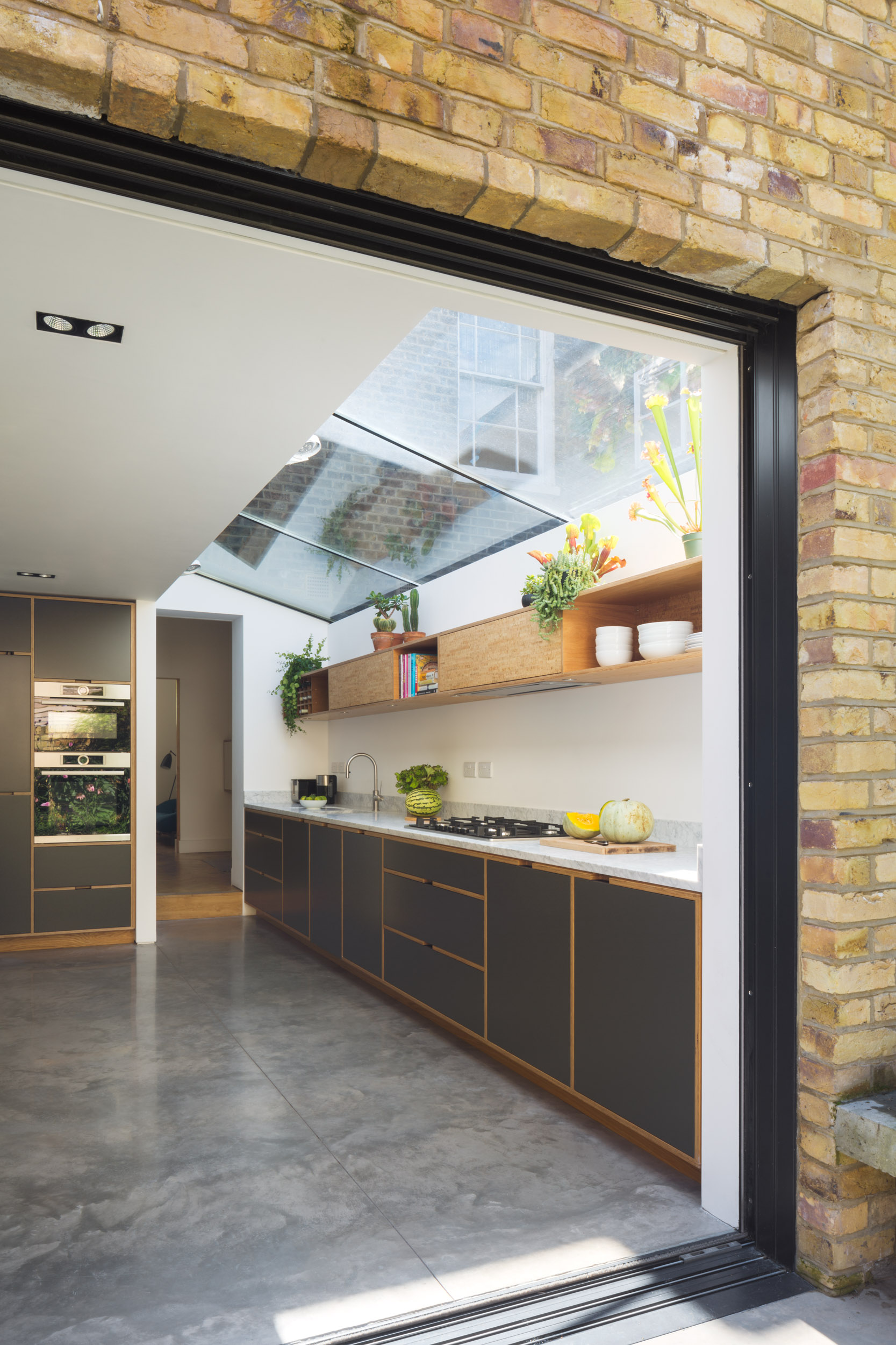 Looking Into Plywood Kitchen From Outside With Window Doors Open