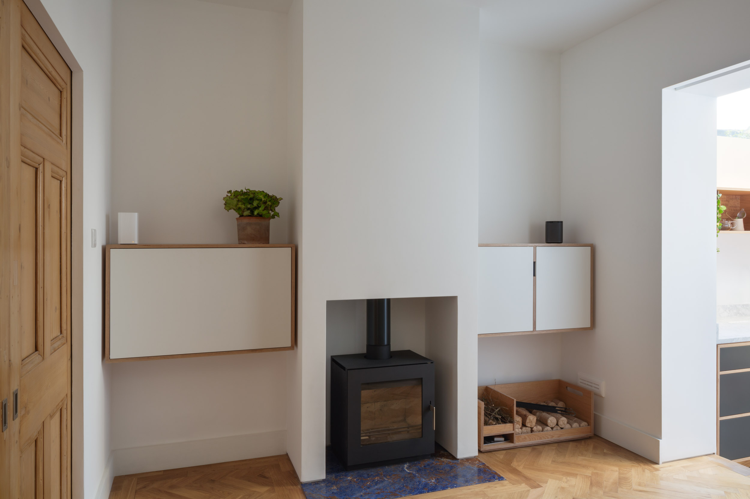 Plywood Living Area Featuring Wood Burning Stove and fold down desk