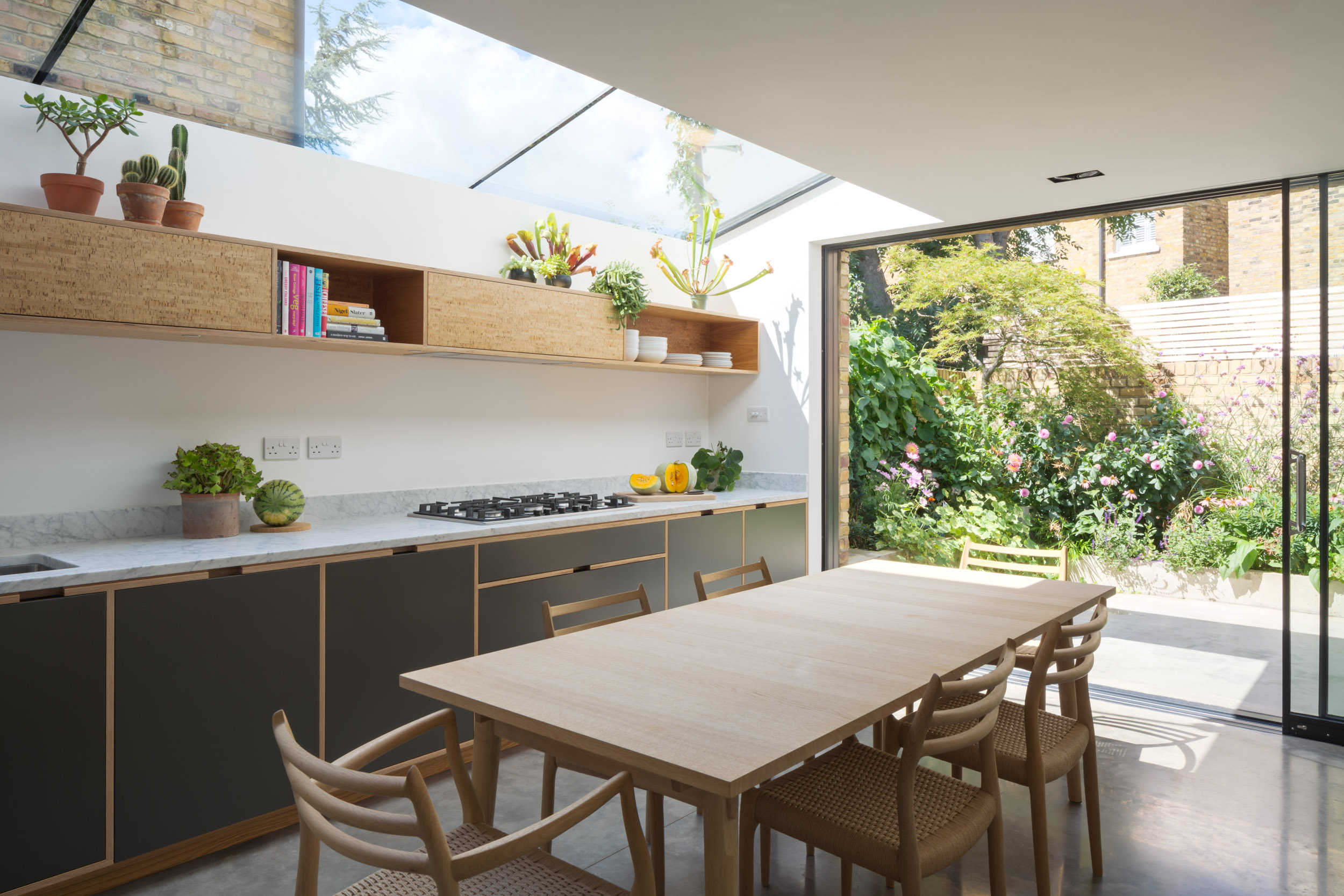 Open plan Plywood Kitchen Overlooking Garden With Floor-to-Ceiling doors