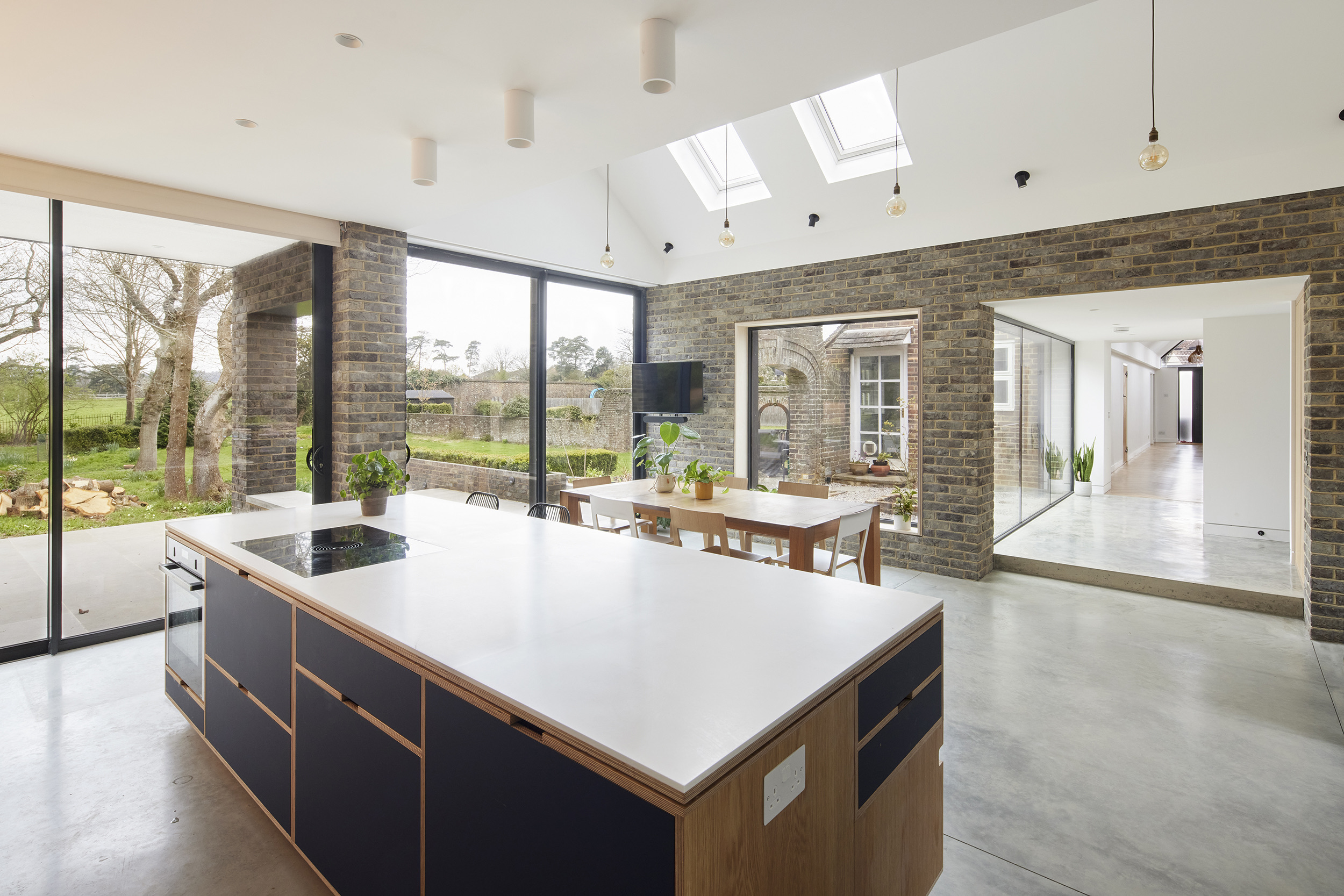 Rear extension to a Victorian property featuring a contemporary plywood kitchen by Uncommon Projects, with brick architecture and black metal roof detailing. Architecture by Selencky Parsons.