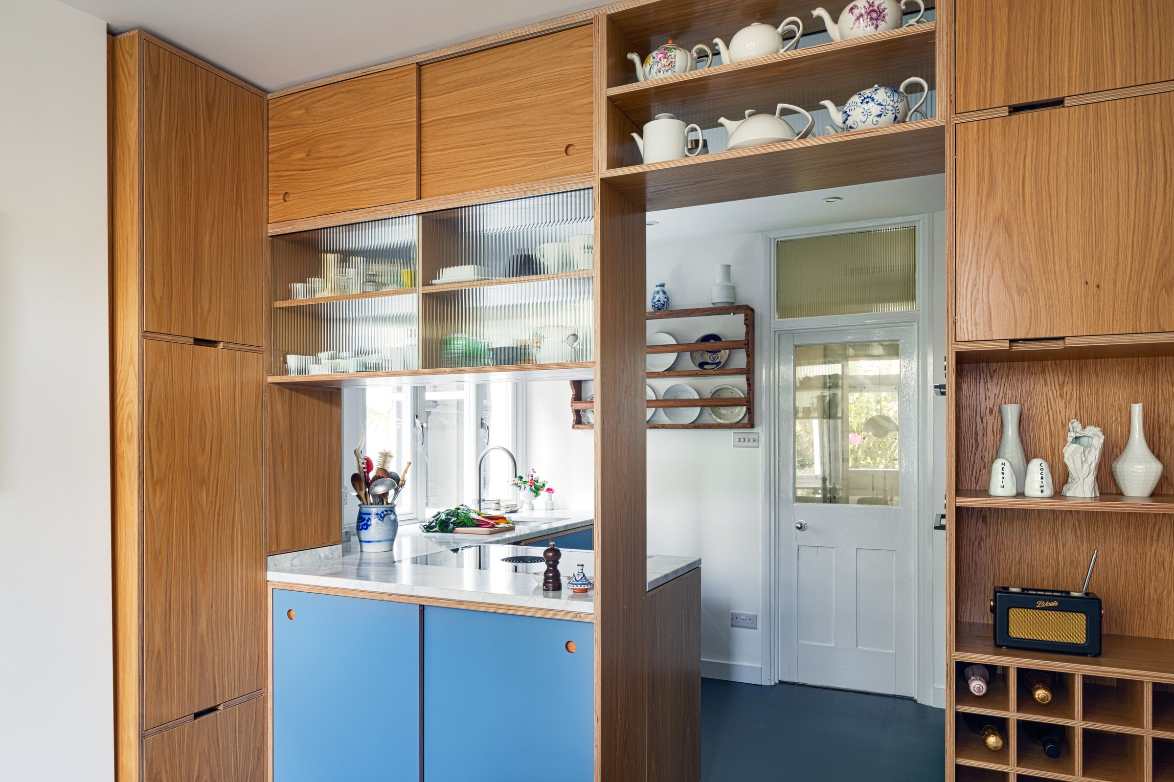 Oak plywood screen with teapot shelf, fluted glass cabinets, wine rack and serving hatch to the kitchen, Forest Gate