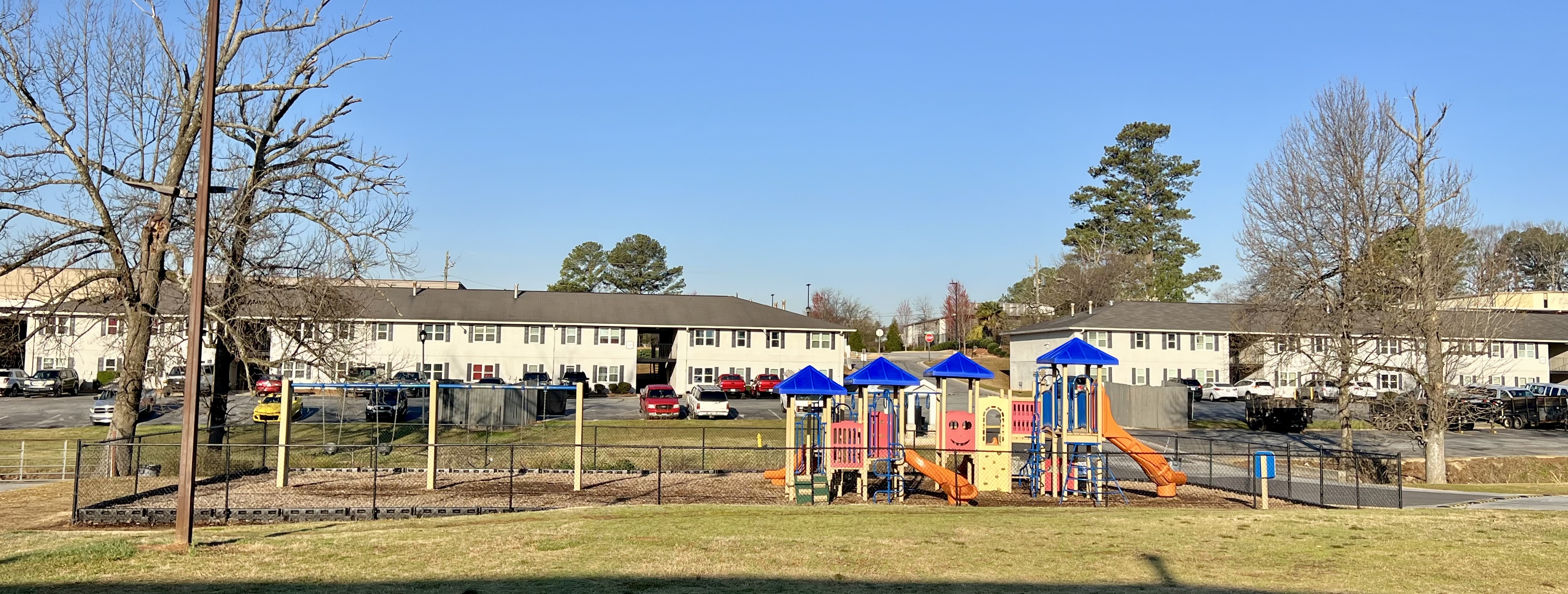 Fenced playground with view of exterior