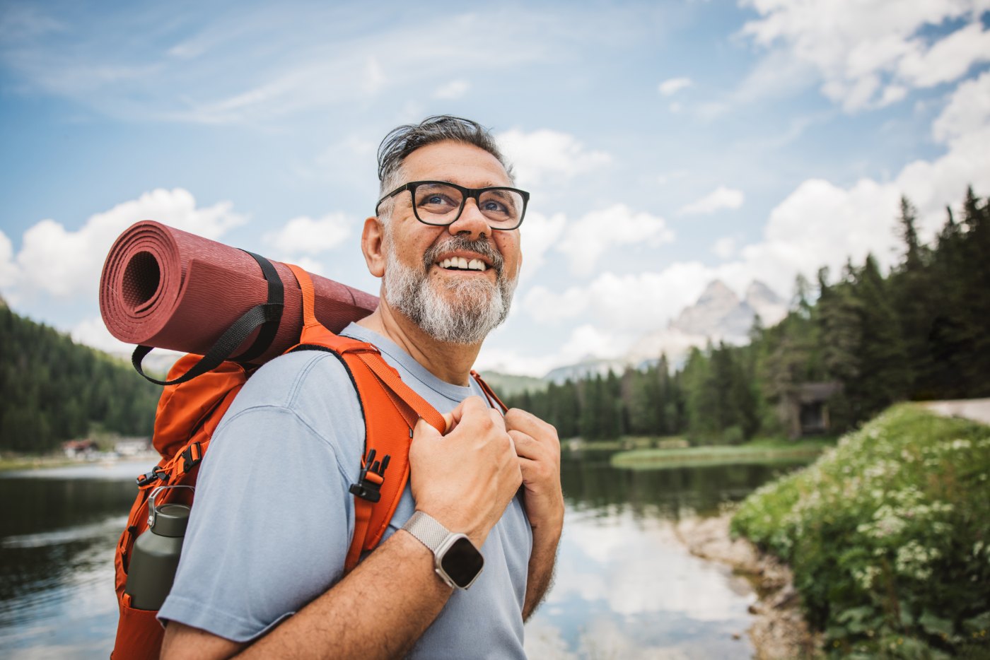 Smiling hiker by a mountain lake