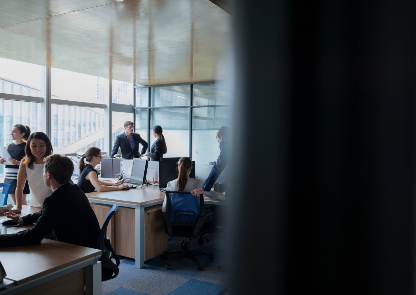 Consultants and clients meeting in a bright open-plan office