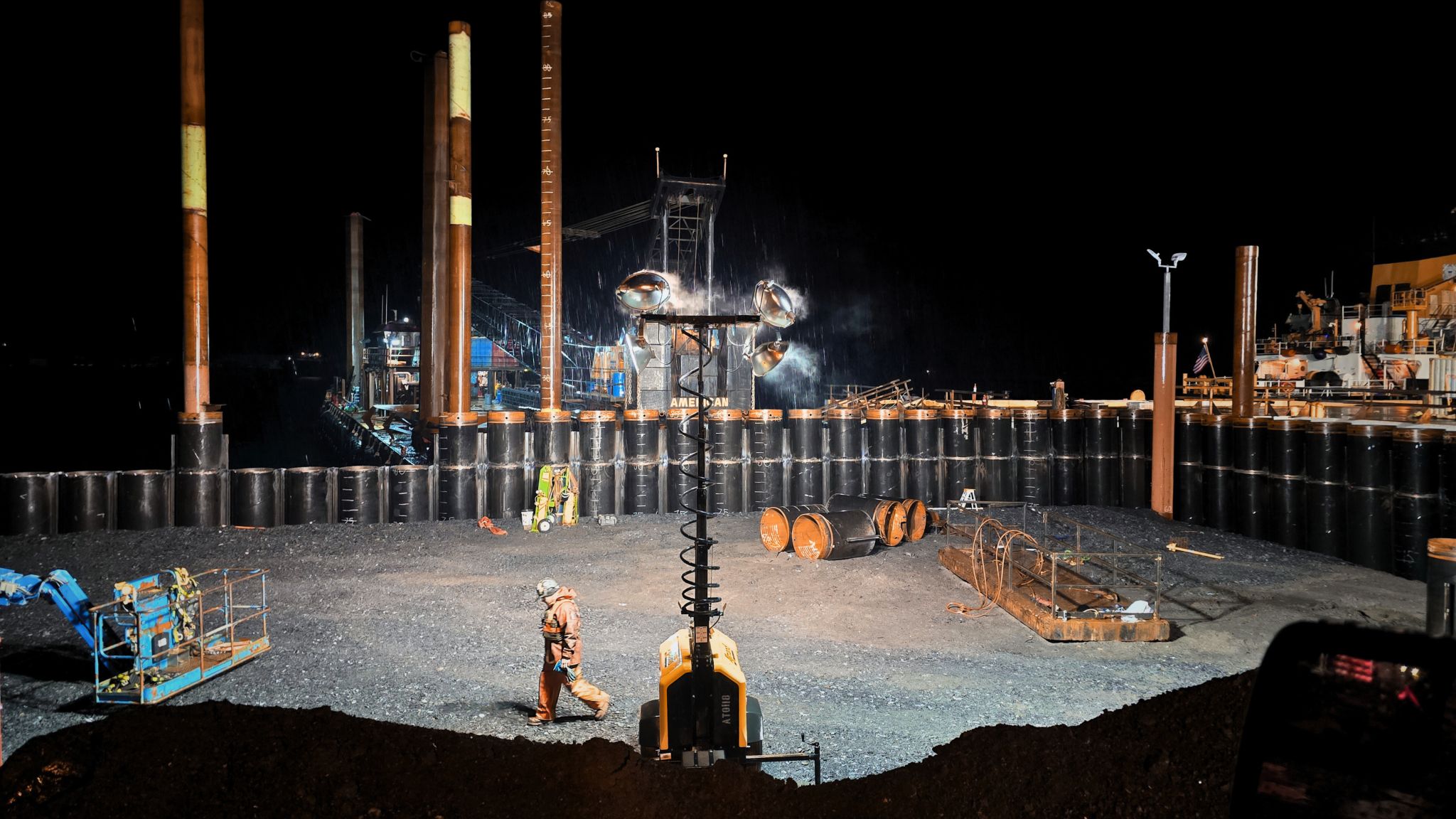 Nighttime photo of steel piles installation in Alaska
