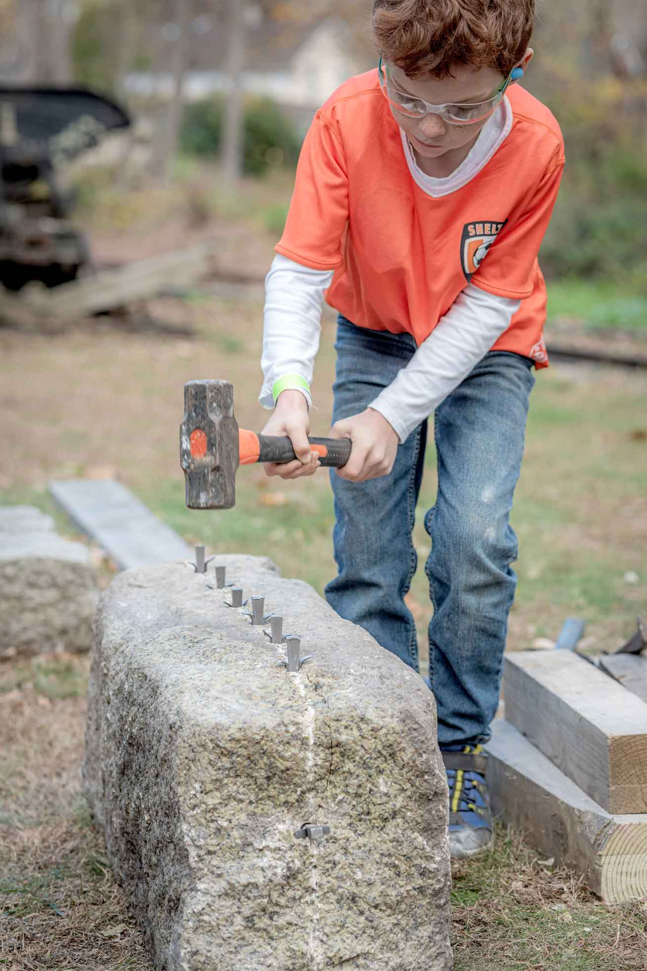 Boy practicing stone masonry