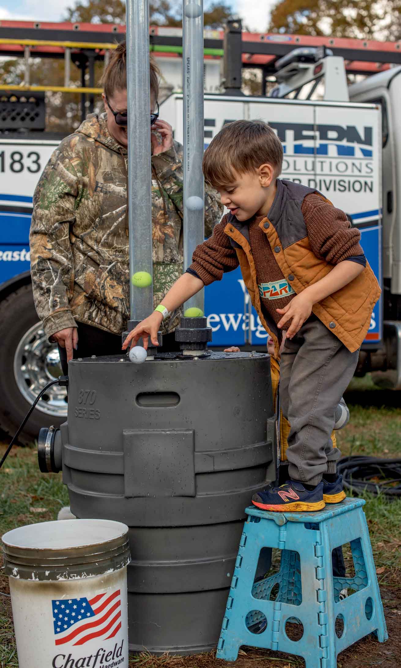 Boy experimenting with volume displacement.