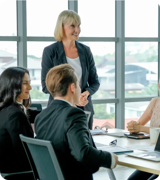 A woman in a business suit giving a presentation to a group of people in a conference room.