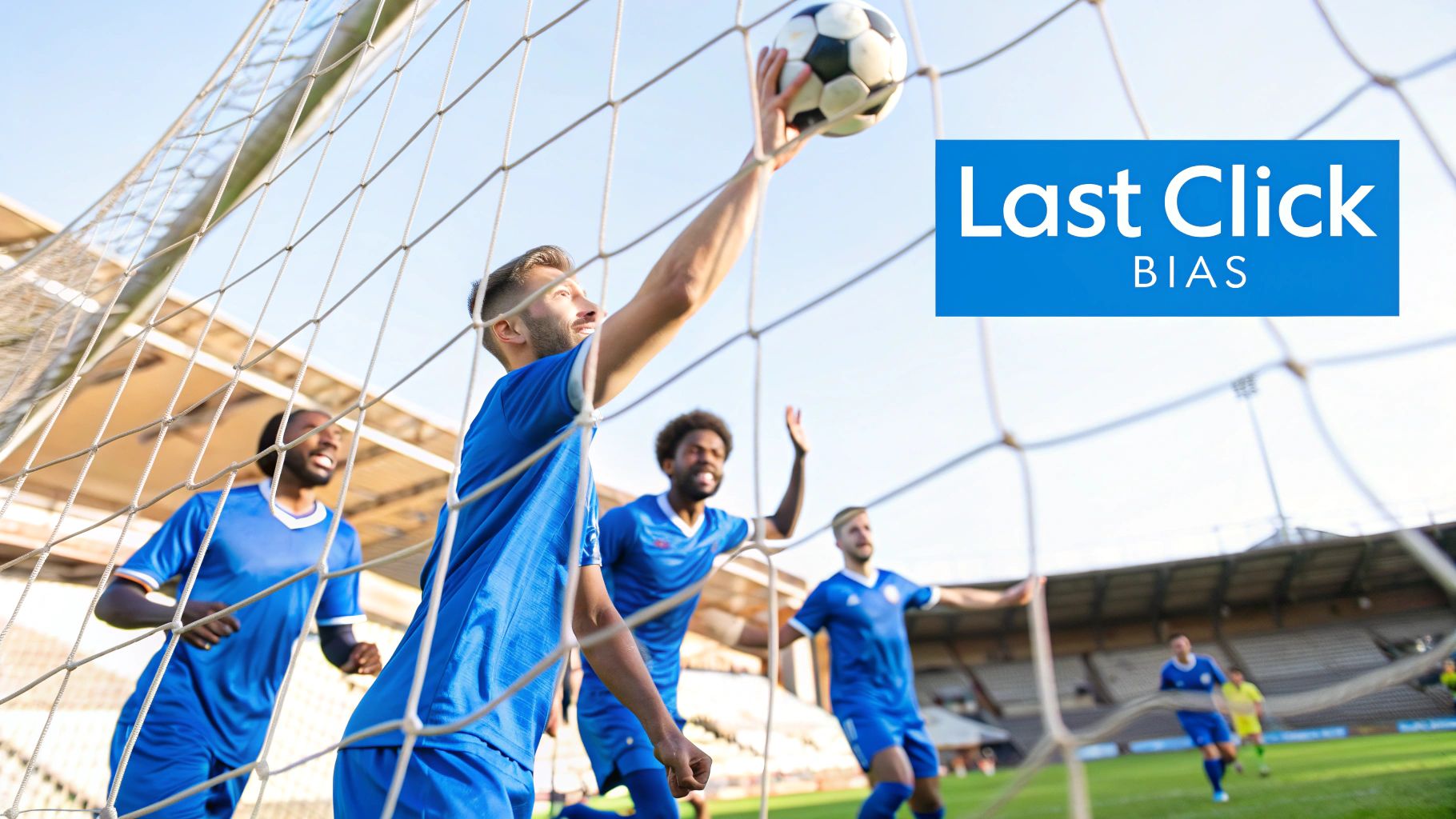 A male soccer player in a blue jersey blocking a ball near the goal net during a game.