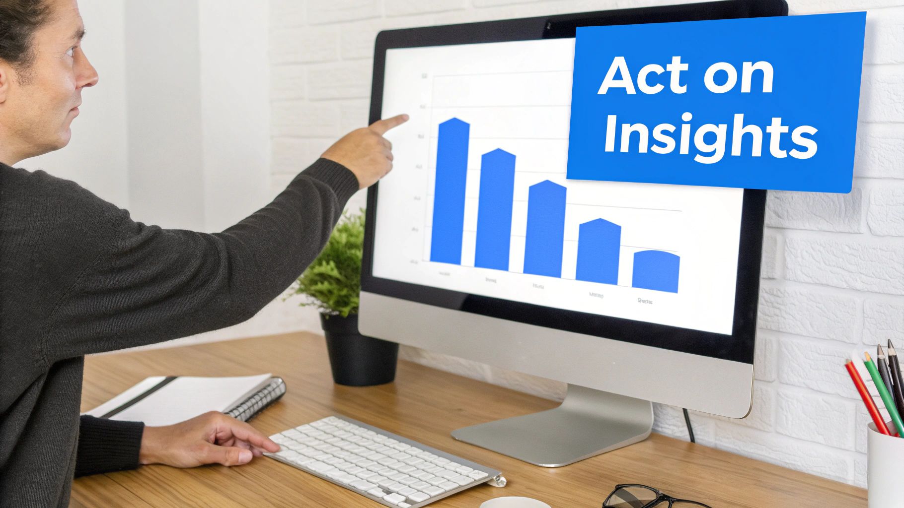 A person points at a monitor showing a bar chart and the text "Act on Insights," representing data analysis.