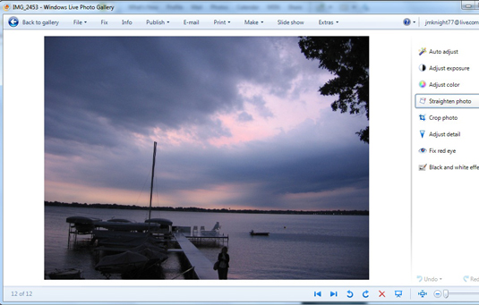 Open the Windows Live Photo Gallery, click the tilting photo, and click the Fix button on the toolbar.