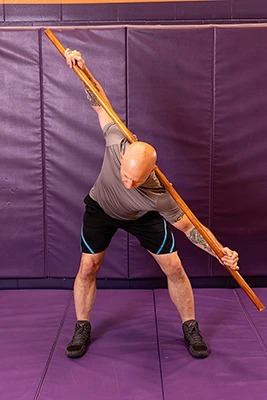 man demonstrating bent over twist