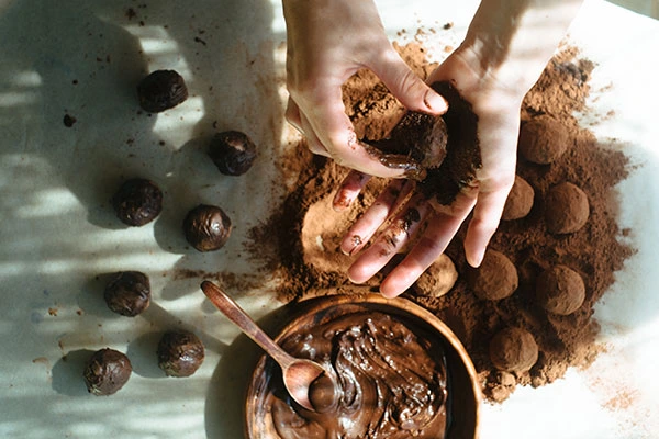 person making homemade chocolate truffles