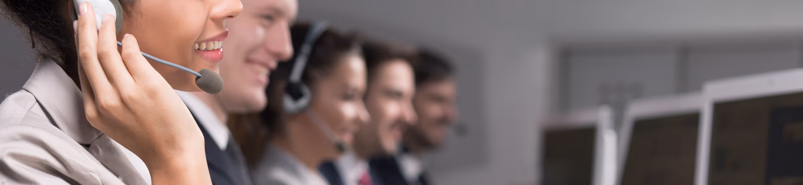 A woman wearing a headset and talking on a cell phone.