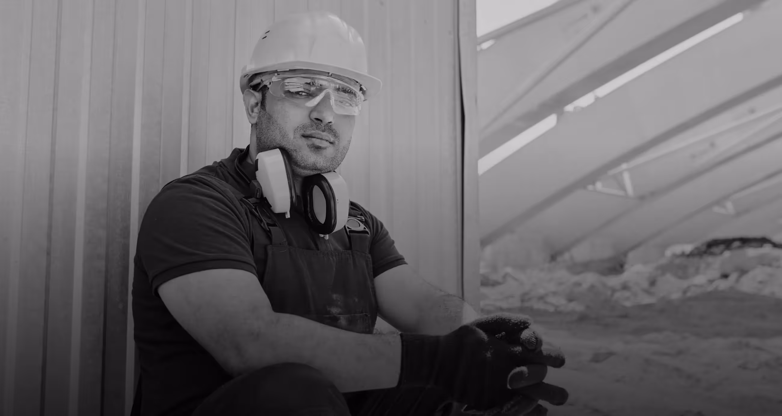 A man wearing a hard hat and safety goggles.