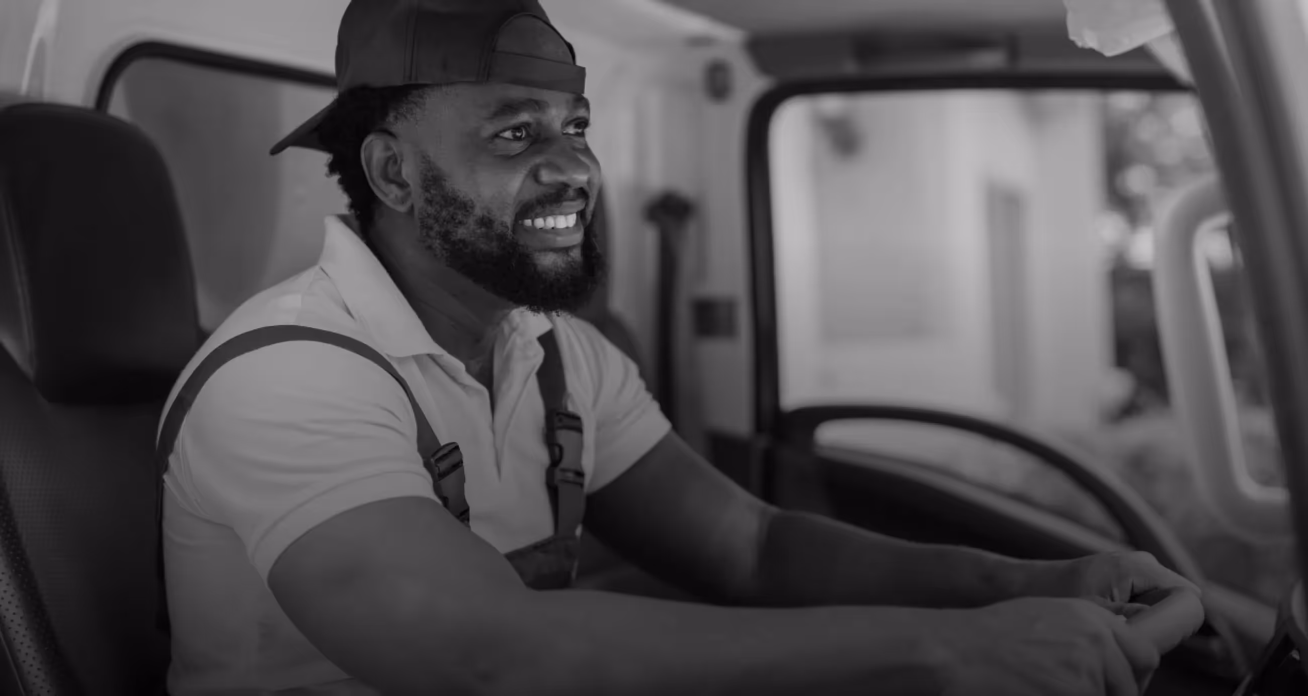 A man sitting in the driver's seat of a truck.