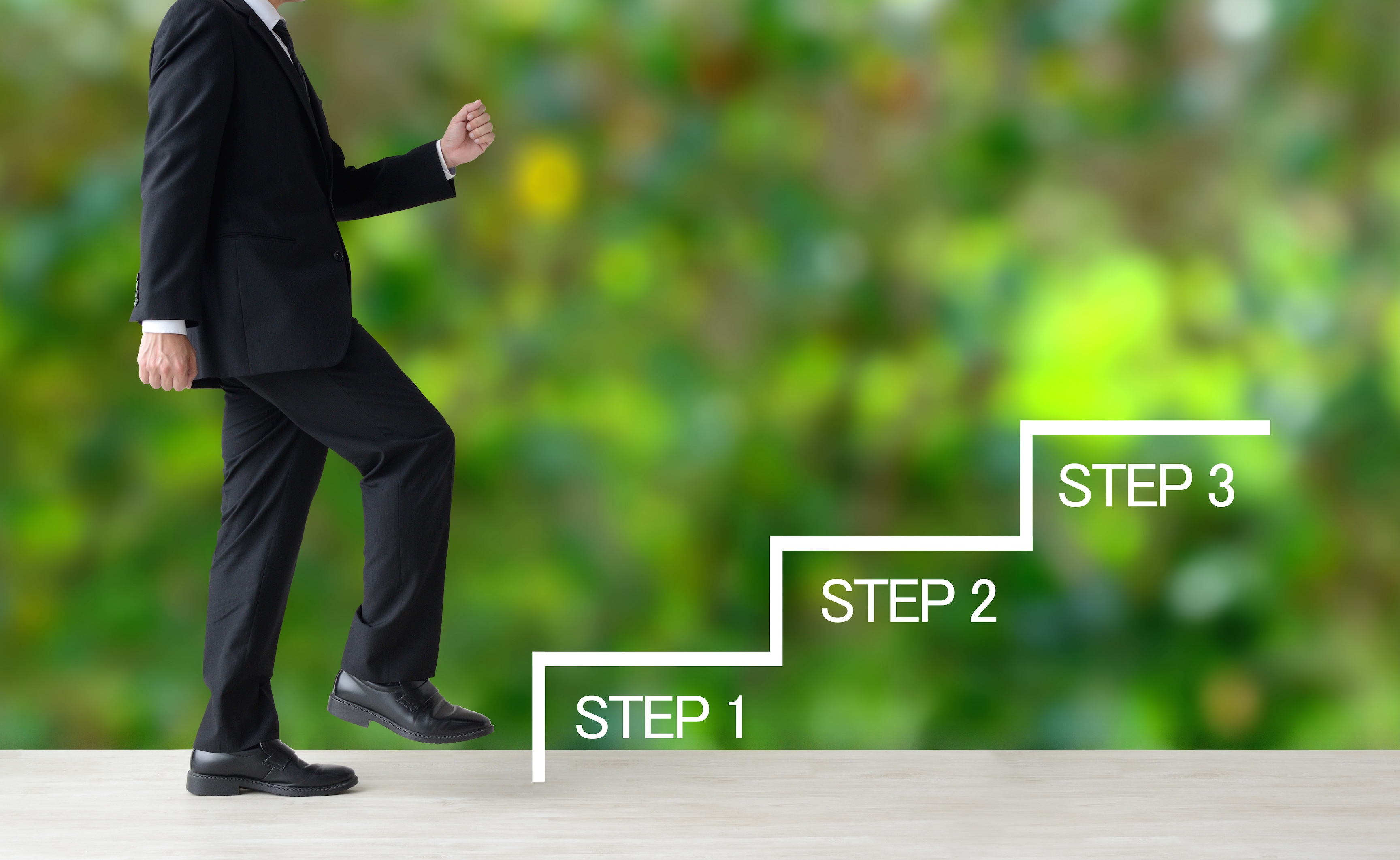 A businessman walking up a staircase labeled Step 1, Step 2, and Step 3, illustrating the 3-step MCA debt payment restructuring process.