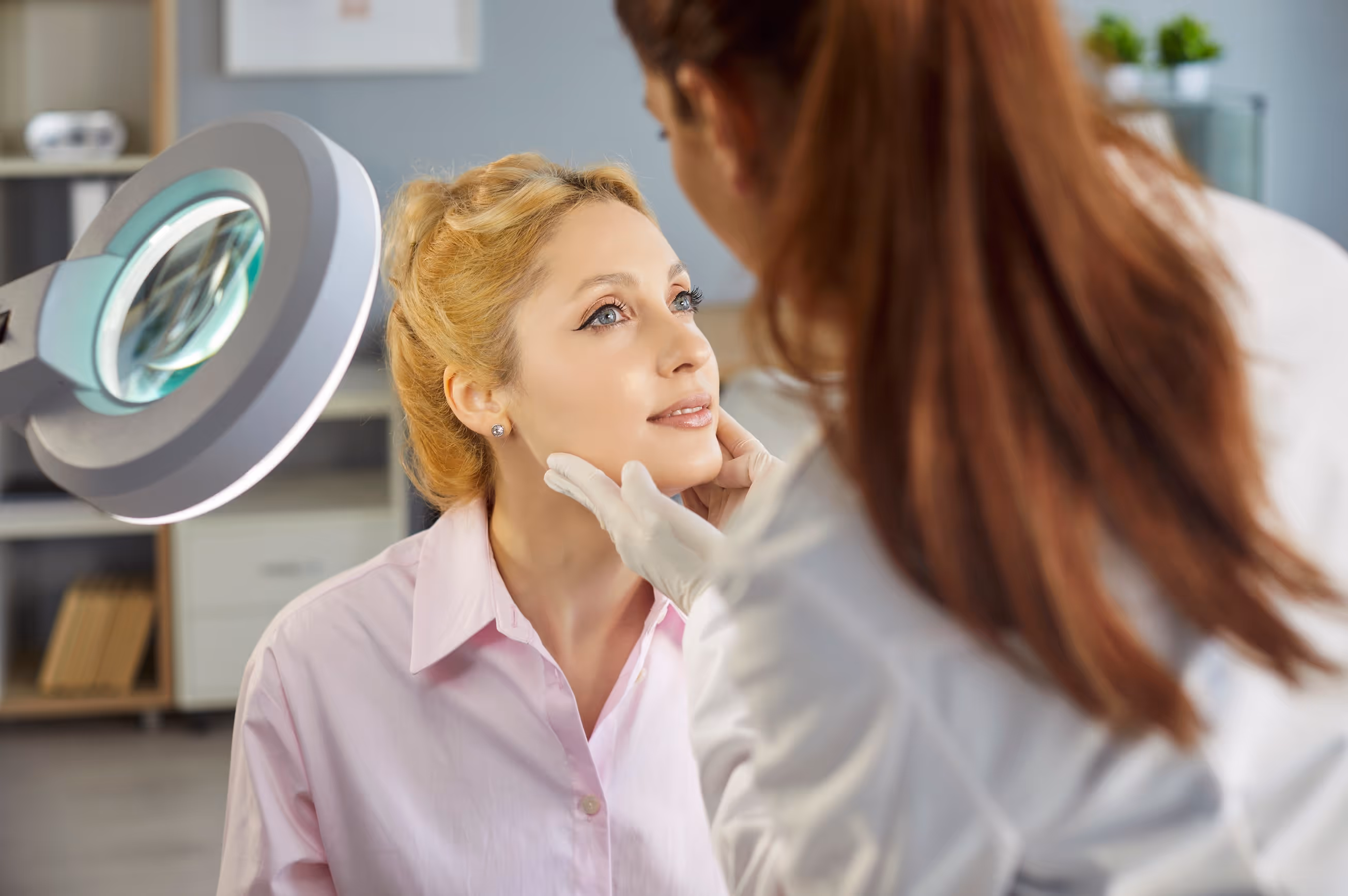 A dermatologist examining a patient, illustrating how healthcare MCA payments strain cash flow during insurance lags.