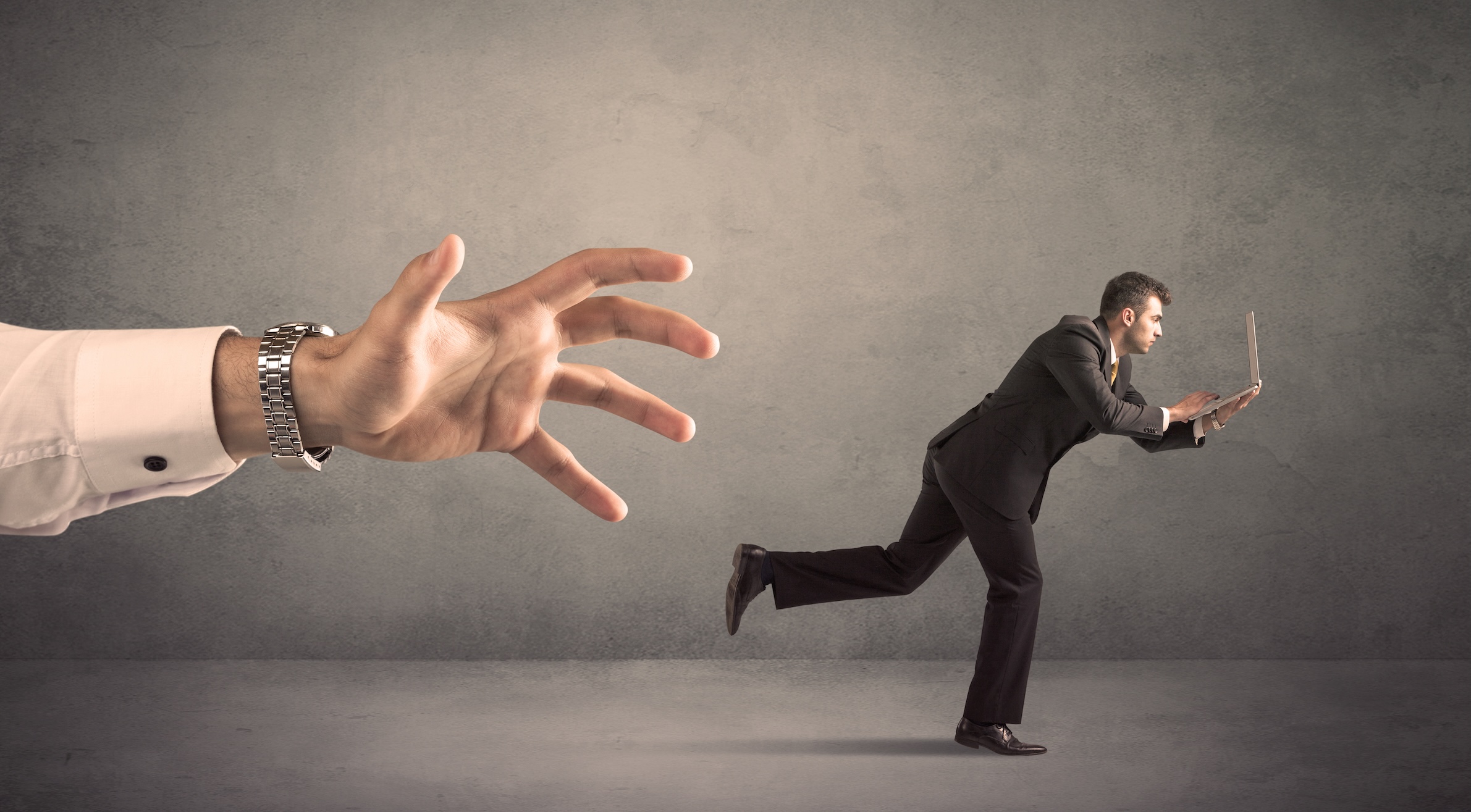 Consequences of defaulting on a Merchant Cash Advance: A businessman running from a giant hand reaching to seize assets.