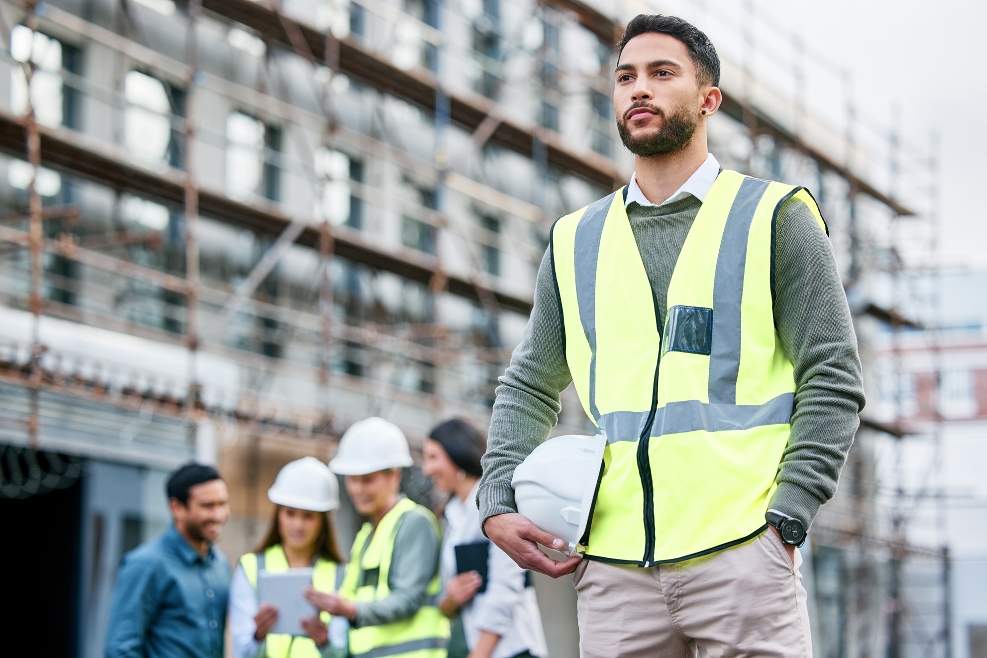 A contractor wearing a safety vest at an active job site, representing financial challenges and solutions for construction businesses dealing with MCA debt.