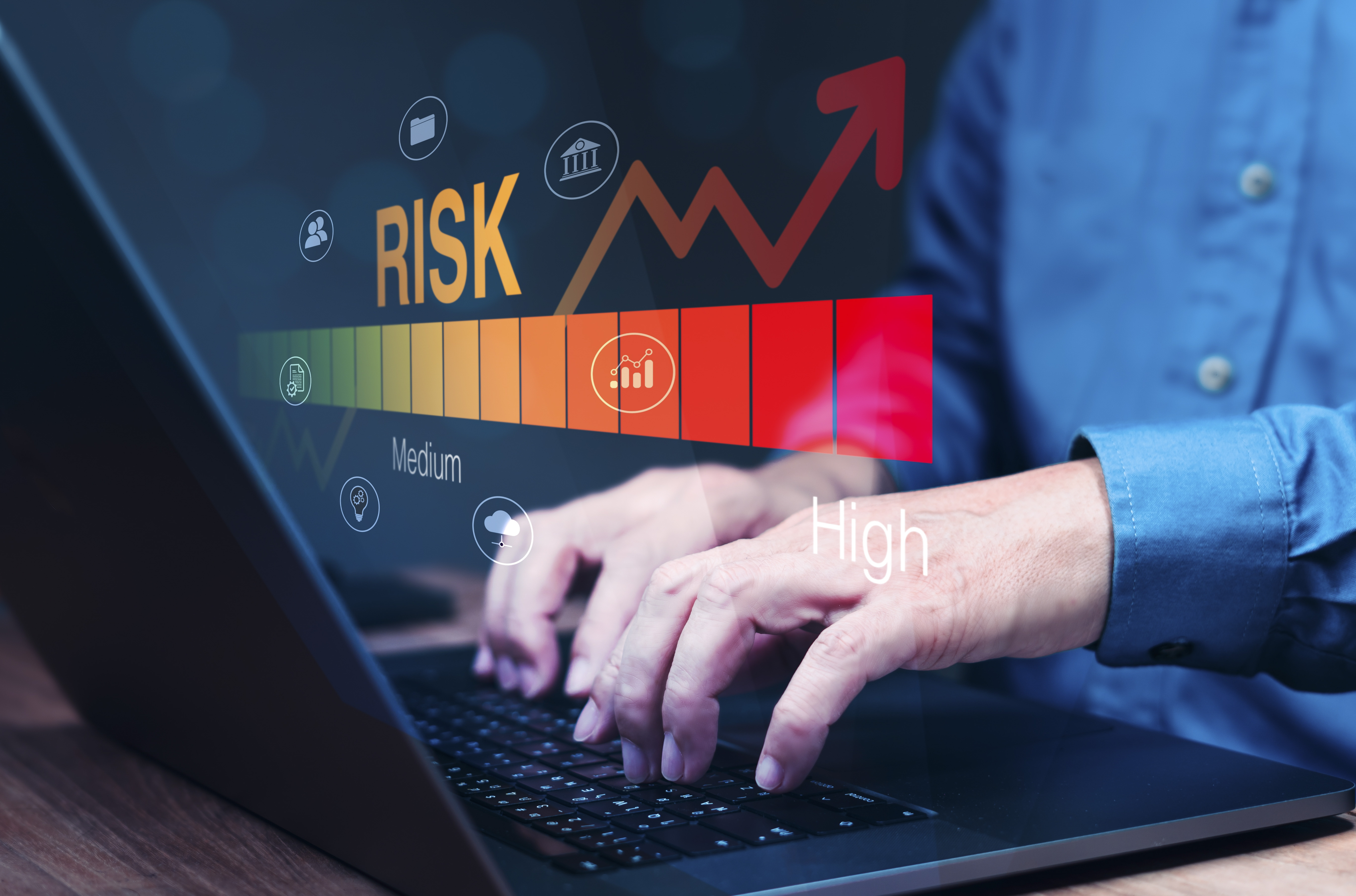 Focused businessman analyzing a high-risk graph on laptop. It represents analyzing risk of taking MCA advances.