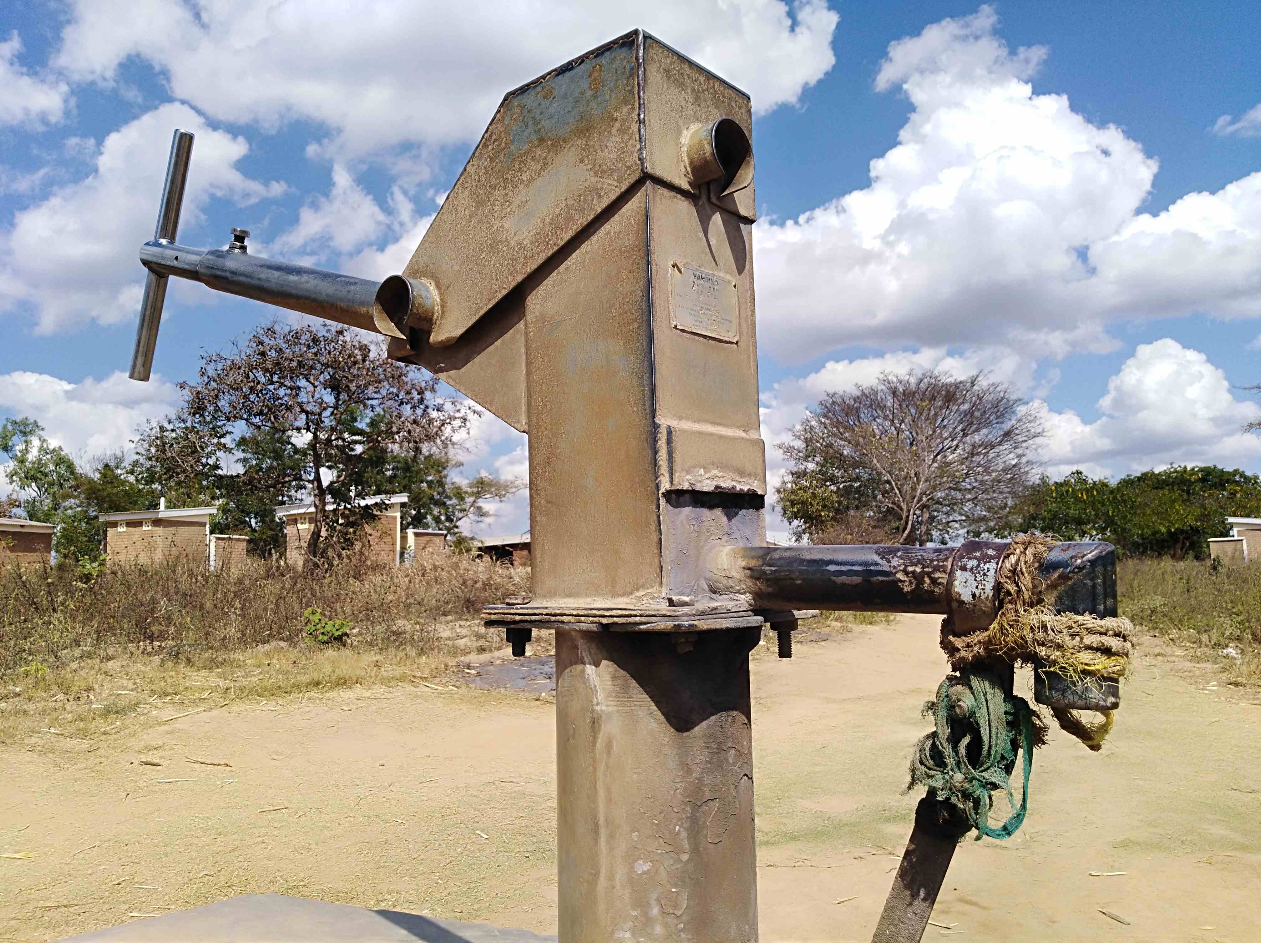 Water user collecting water from handpump