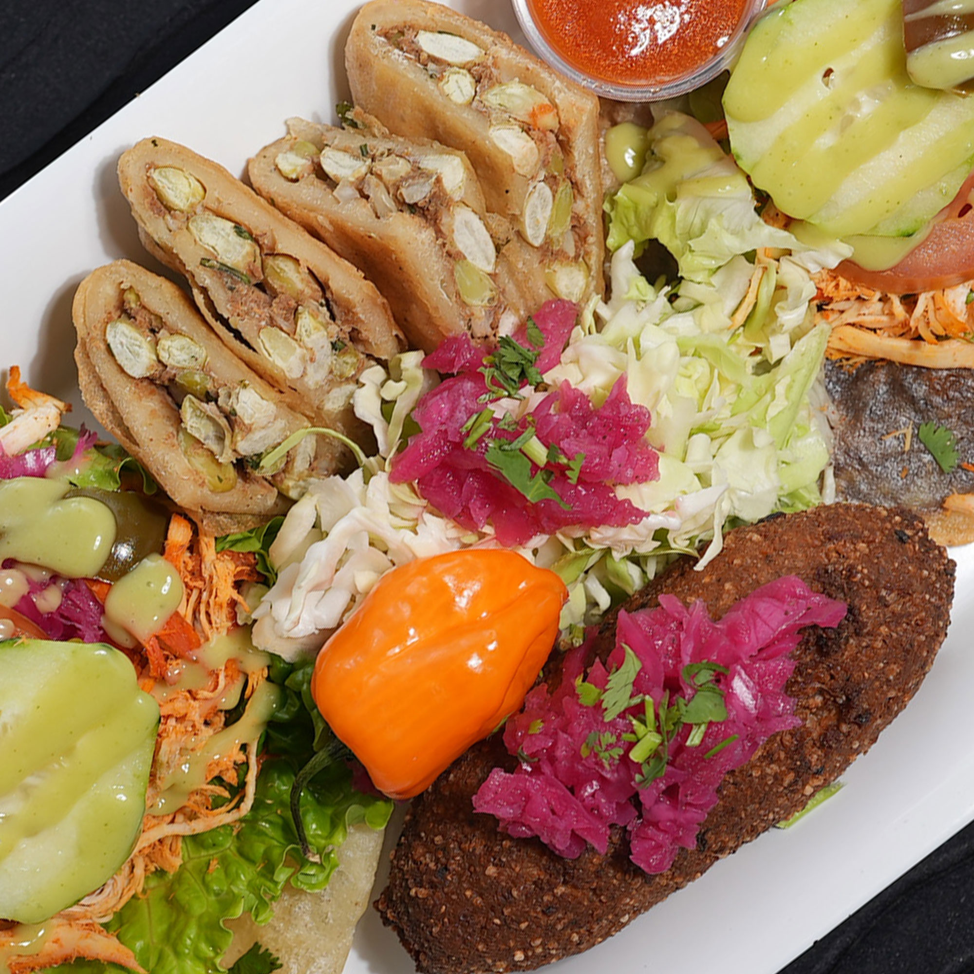 Deep fried corn dough patty stuffed with Iima beans and ground pumpkin seed. Served with pickled cabbage and tomato sauce. Lebanese deep fried meatball, and shredded chicken