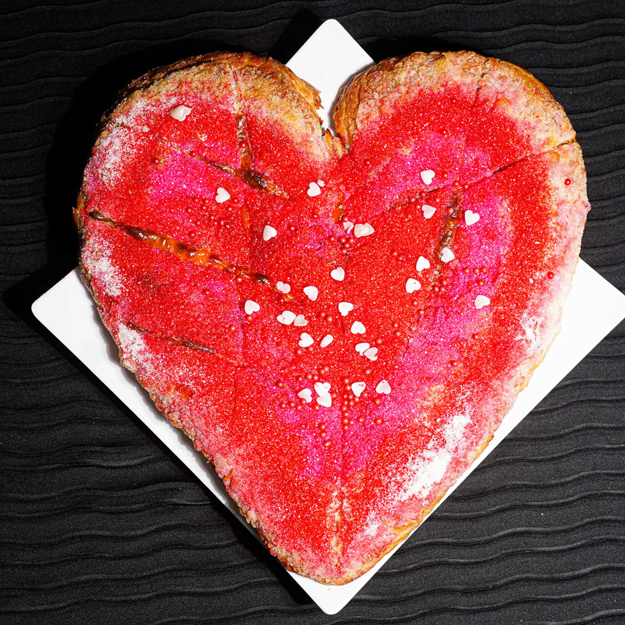 heart shaped bread with red glitter sprinkles