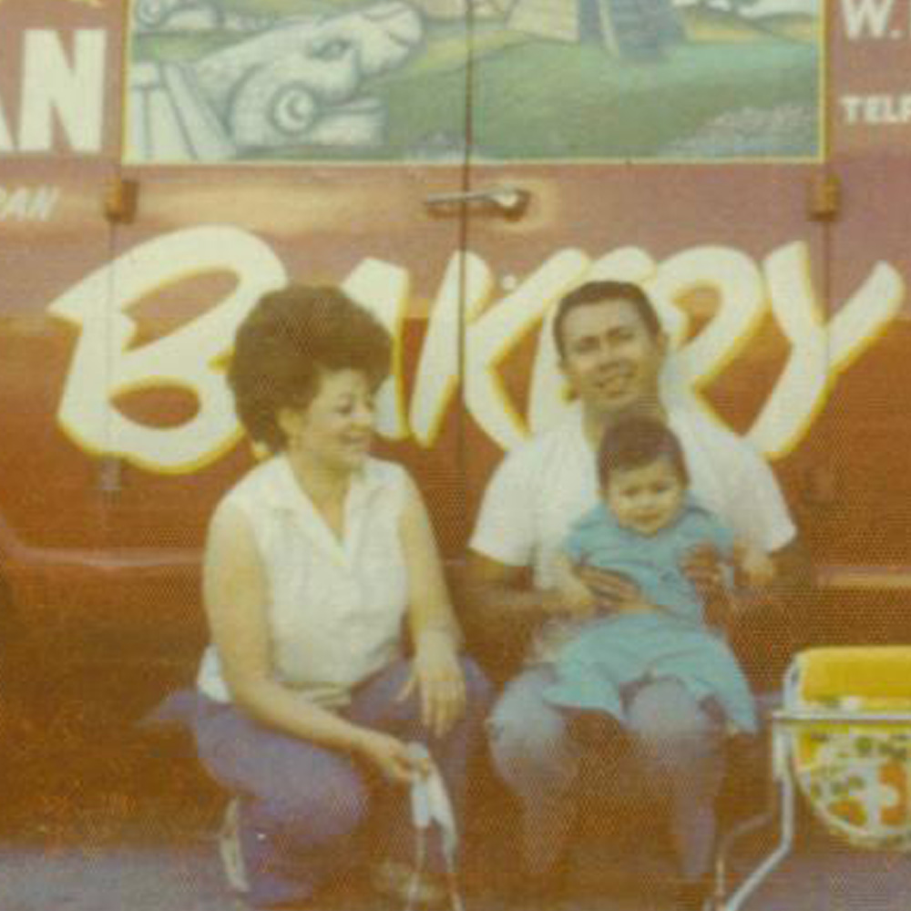 man and woman holding their baby