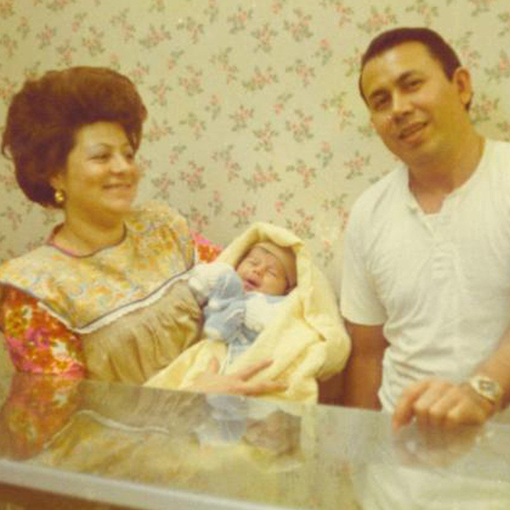 man and woman holding a baby