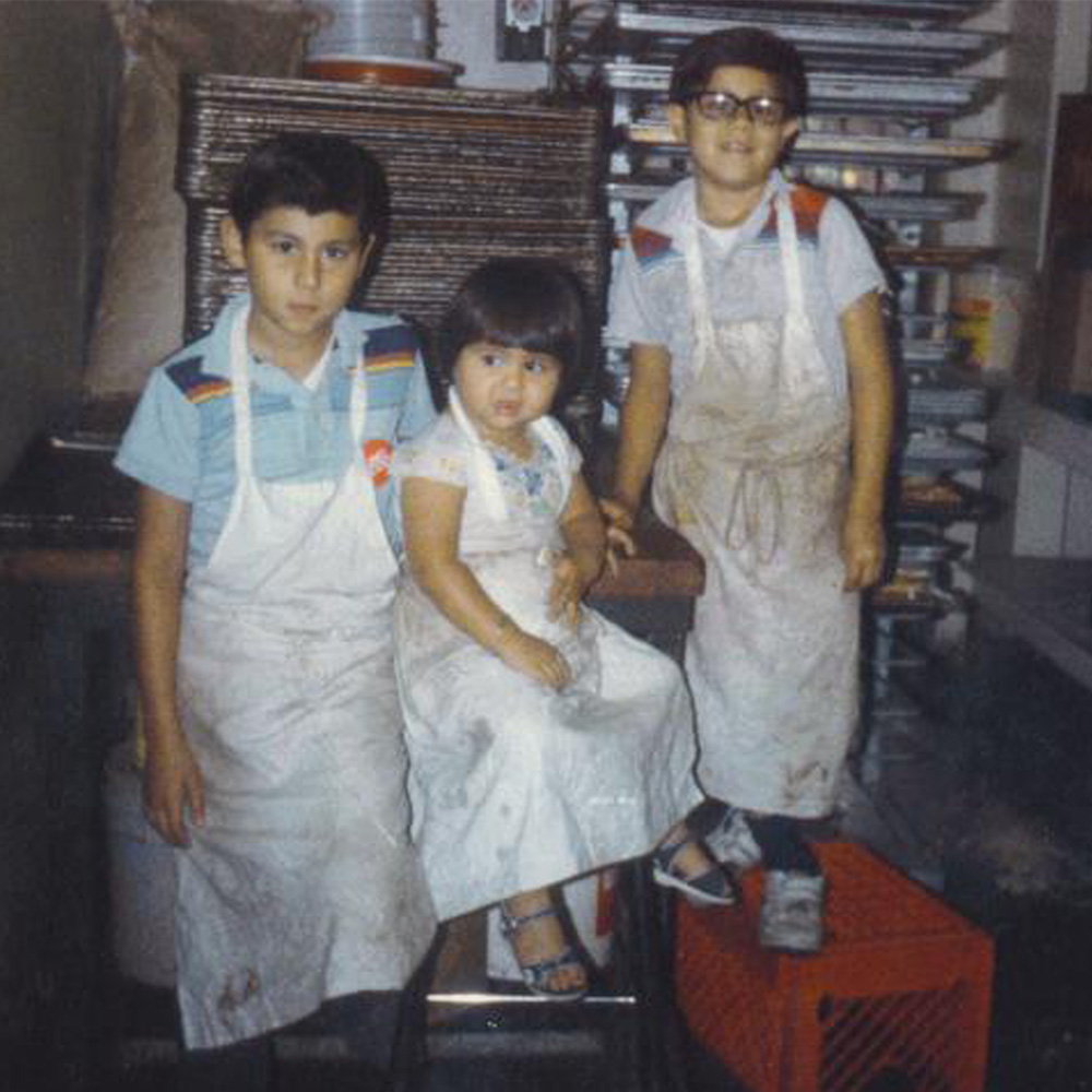three kids wearing aprons