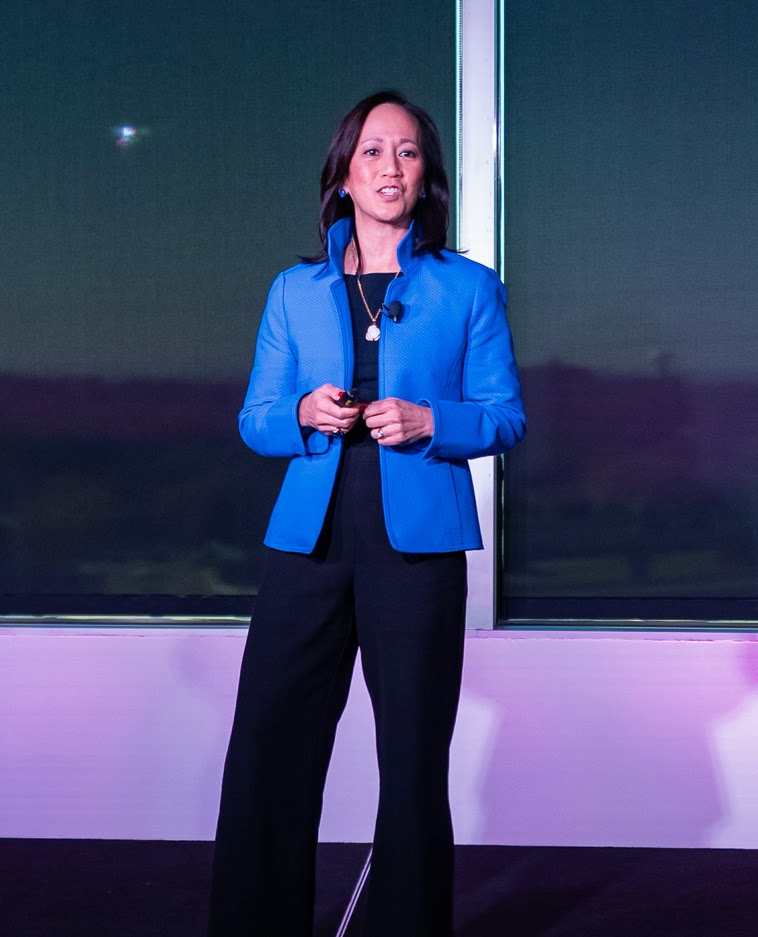 Alissa Hsu Lynch speaking on stage in a blue blazer
