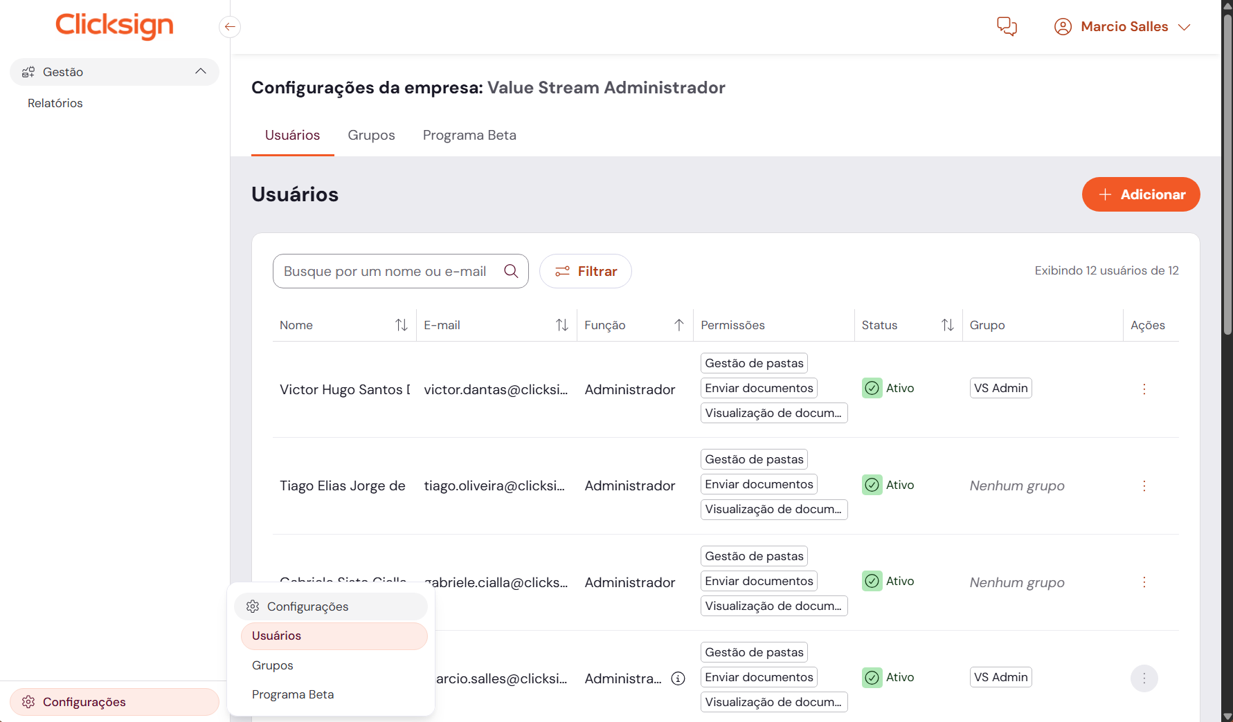 Interface da plataforma Clicksign exibindo a tela de Gestão de Usuários e Configurações da Empresa. A imagem mostra uma lista de usuários cadastrados com suas respectivas funções, permissões (como Gestão de Pastas e Enviar Documentos), status ativo e grupos vinculados. 
