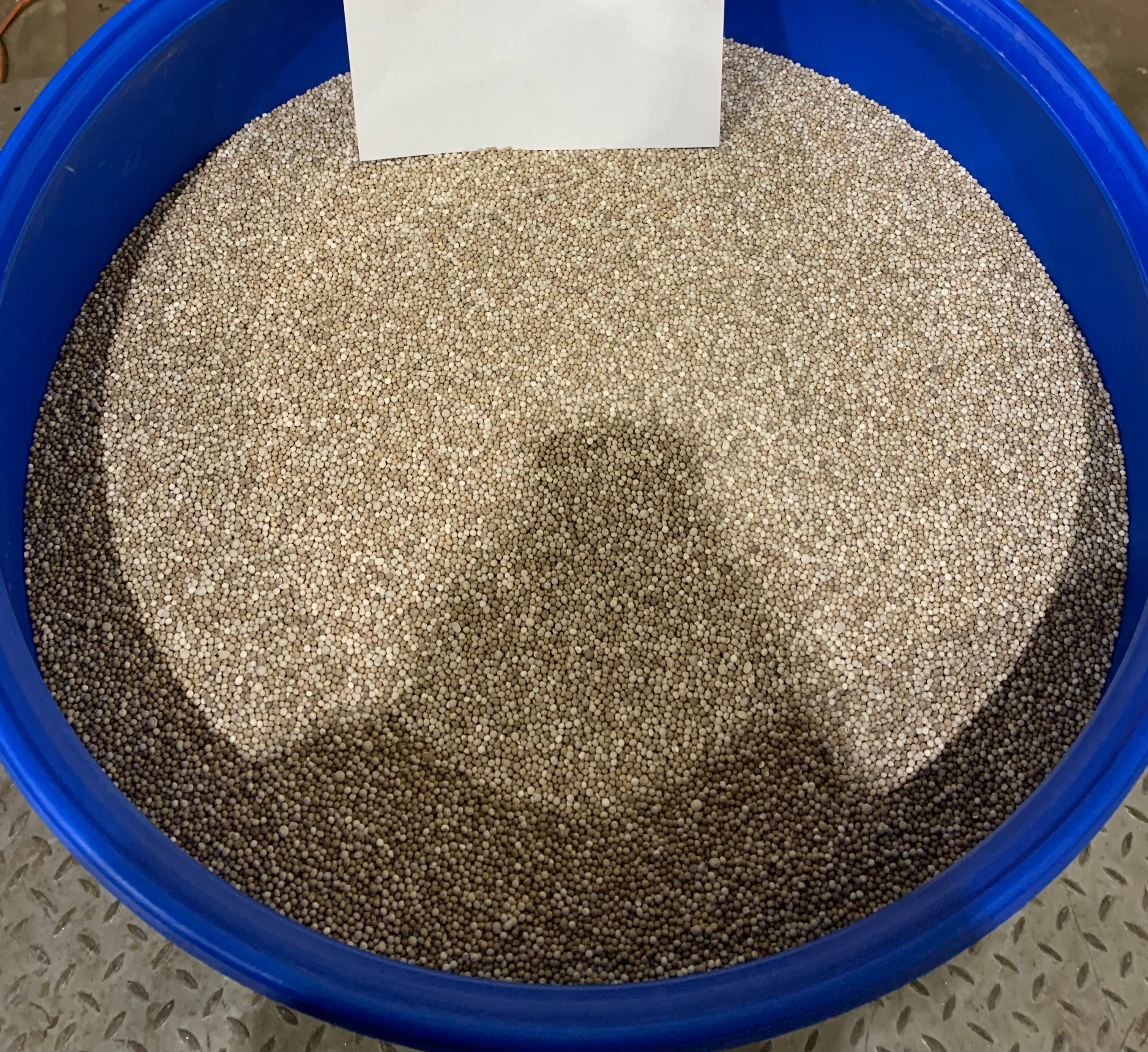 A view of bead catalyst stored in a blue bucket