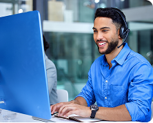 Patient support specialist at a computer