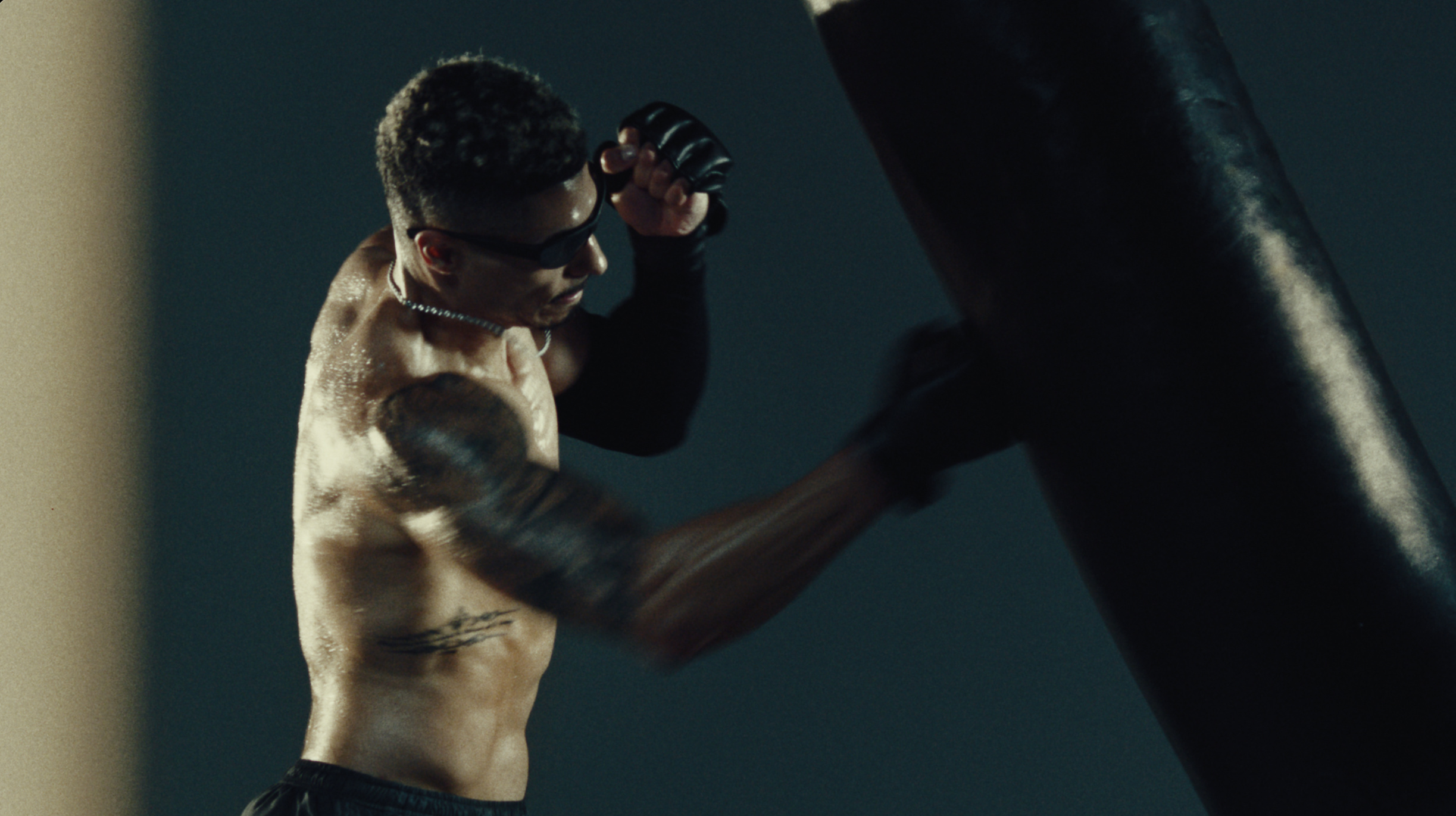 Boxer mid punch driving into an Everlast heavy bag
