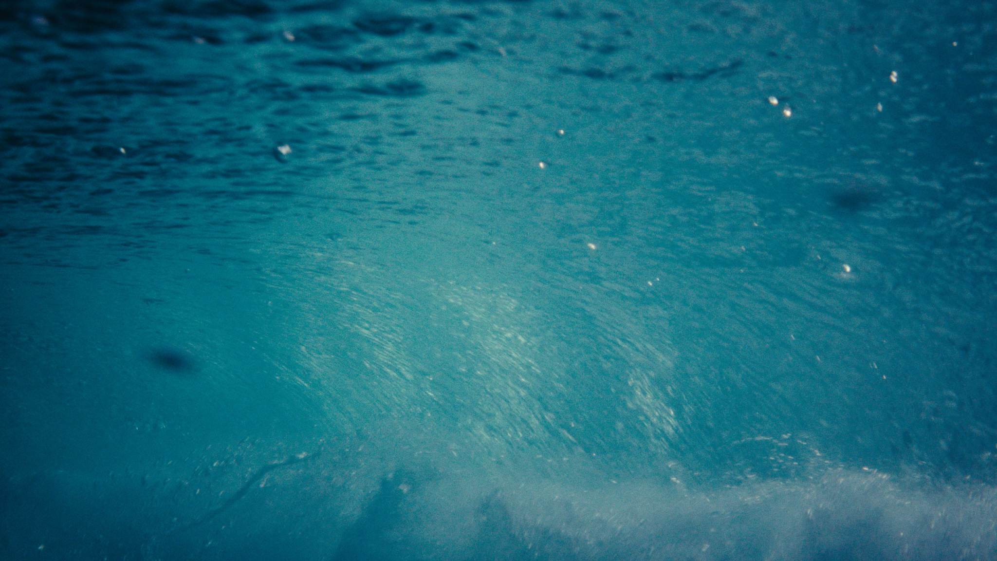 Turquoise underwater foam and bubbles