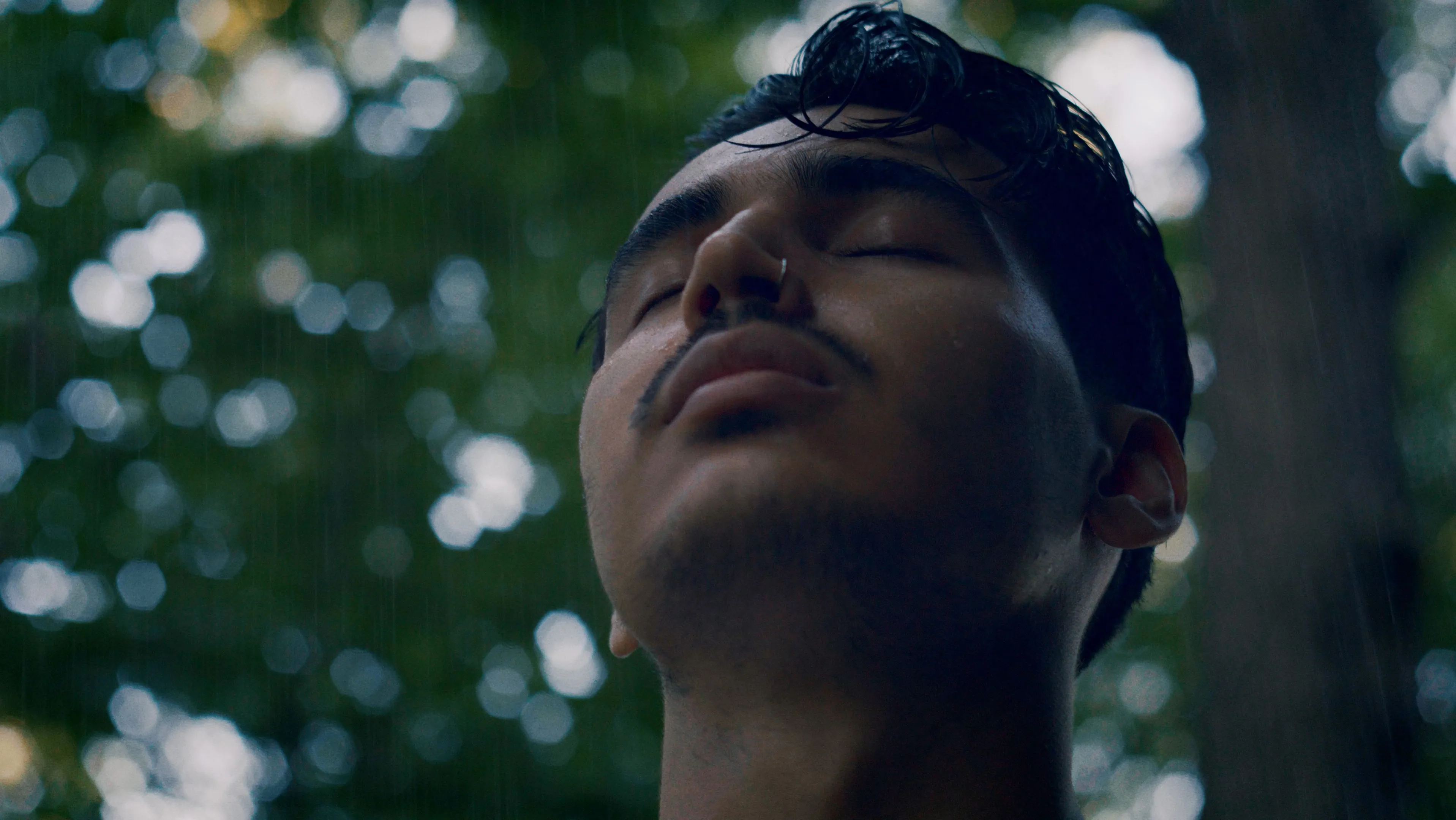 Runner with face upturned and eyes closed in the rain