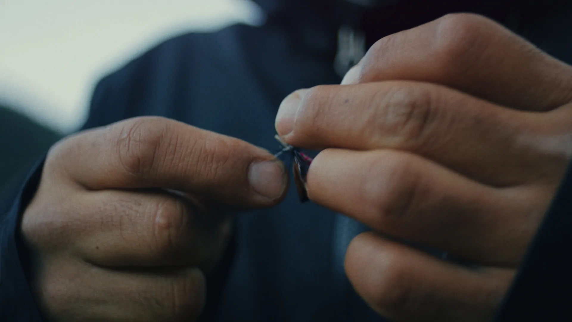 Hands buckling a motorcycle helmet strap