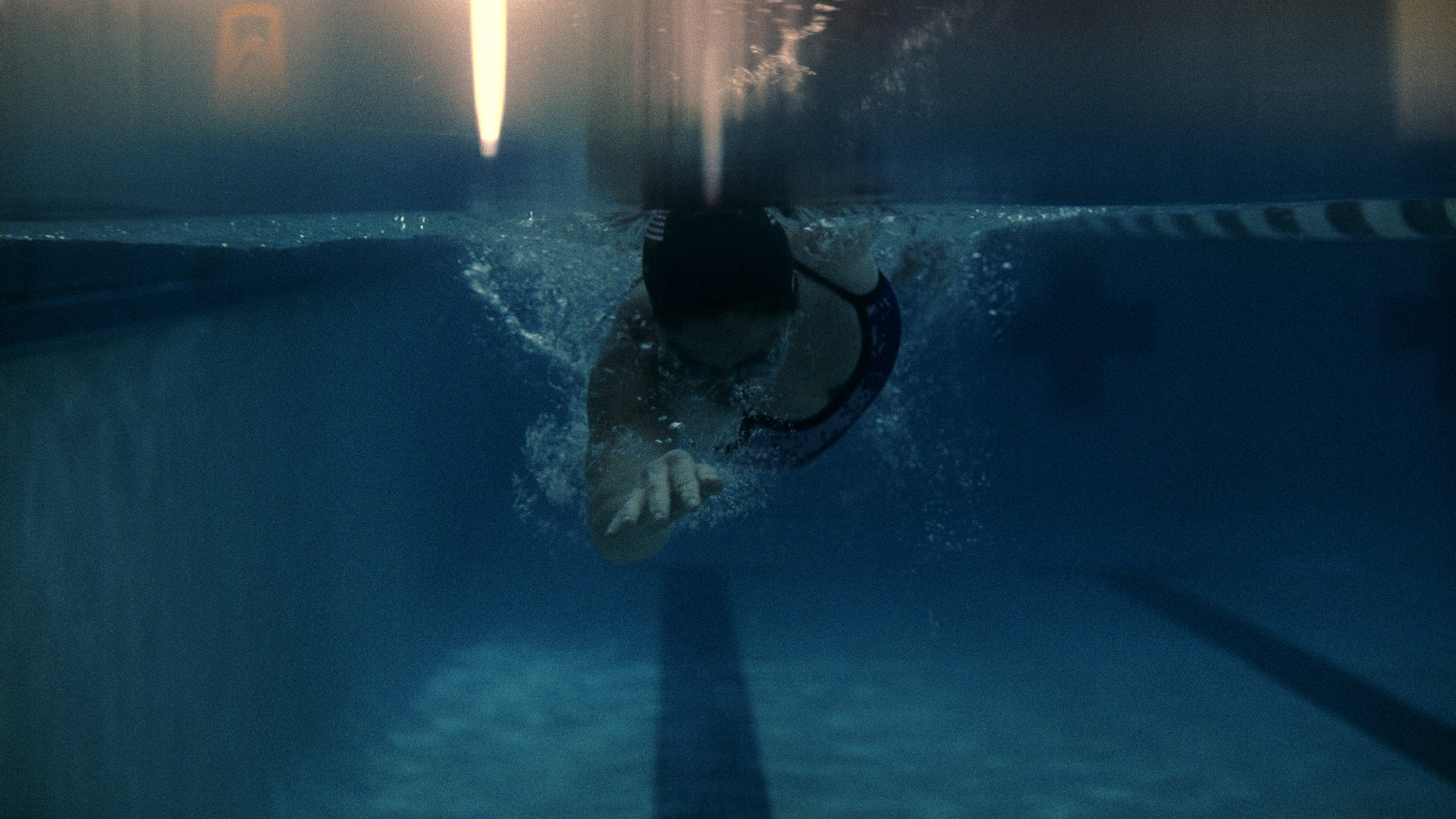 Swimmer pushing off underwater after a dive