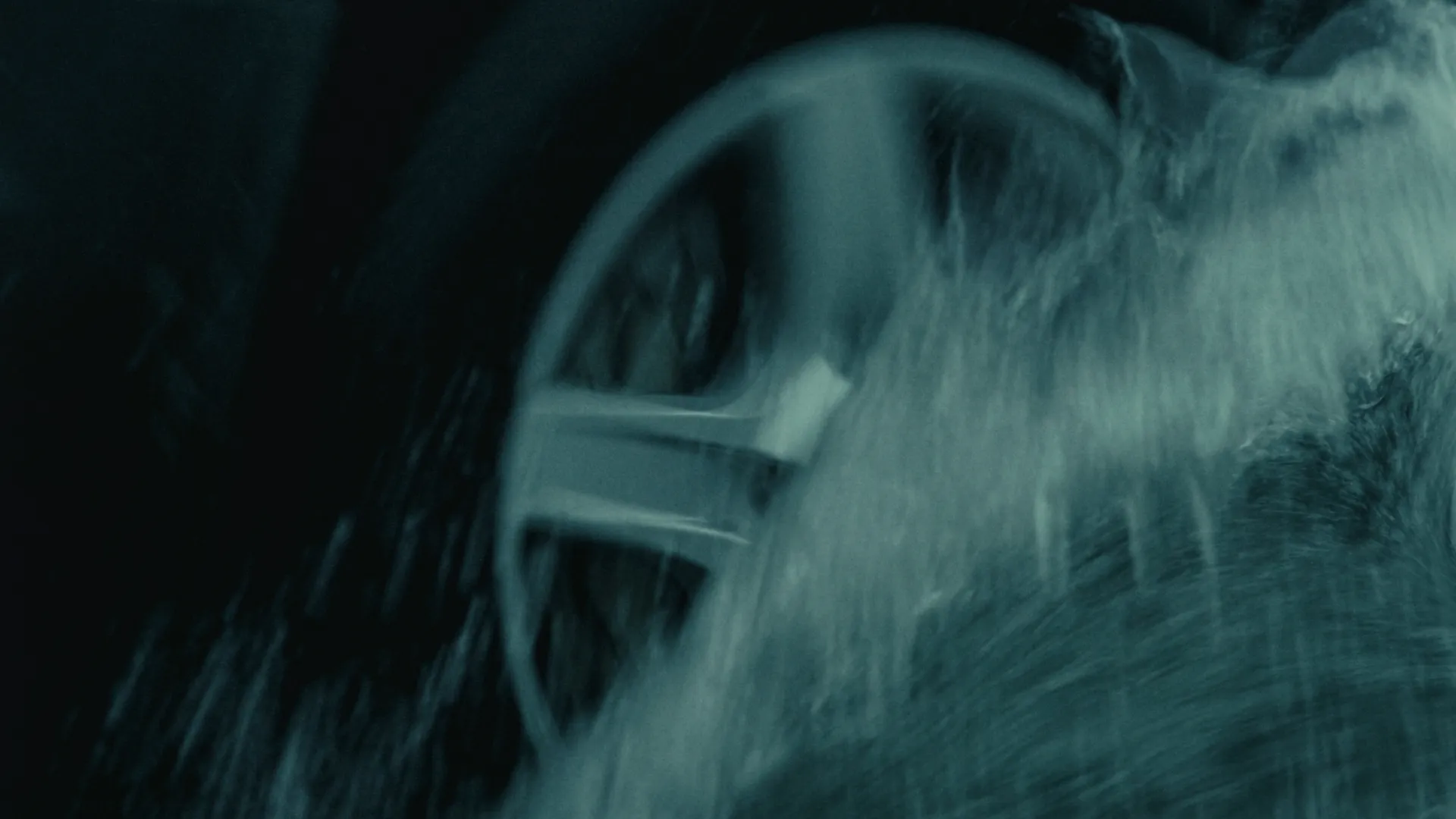 Wheel spinning through water spray up close