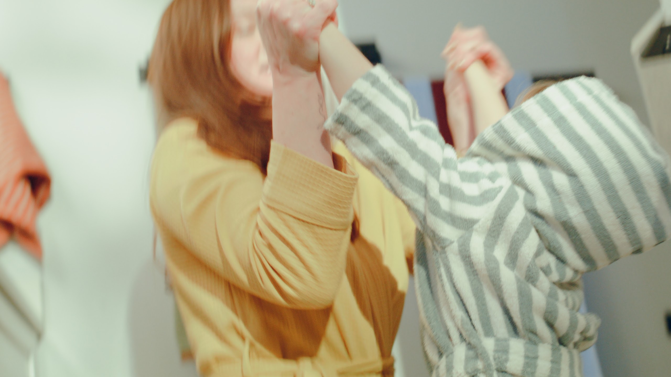 Sisters playing in a bright hallway