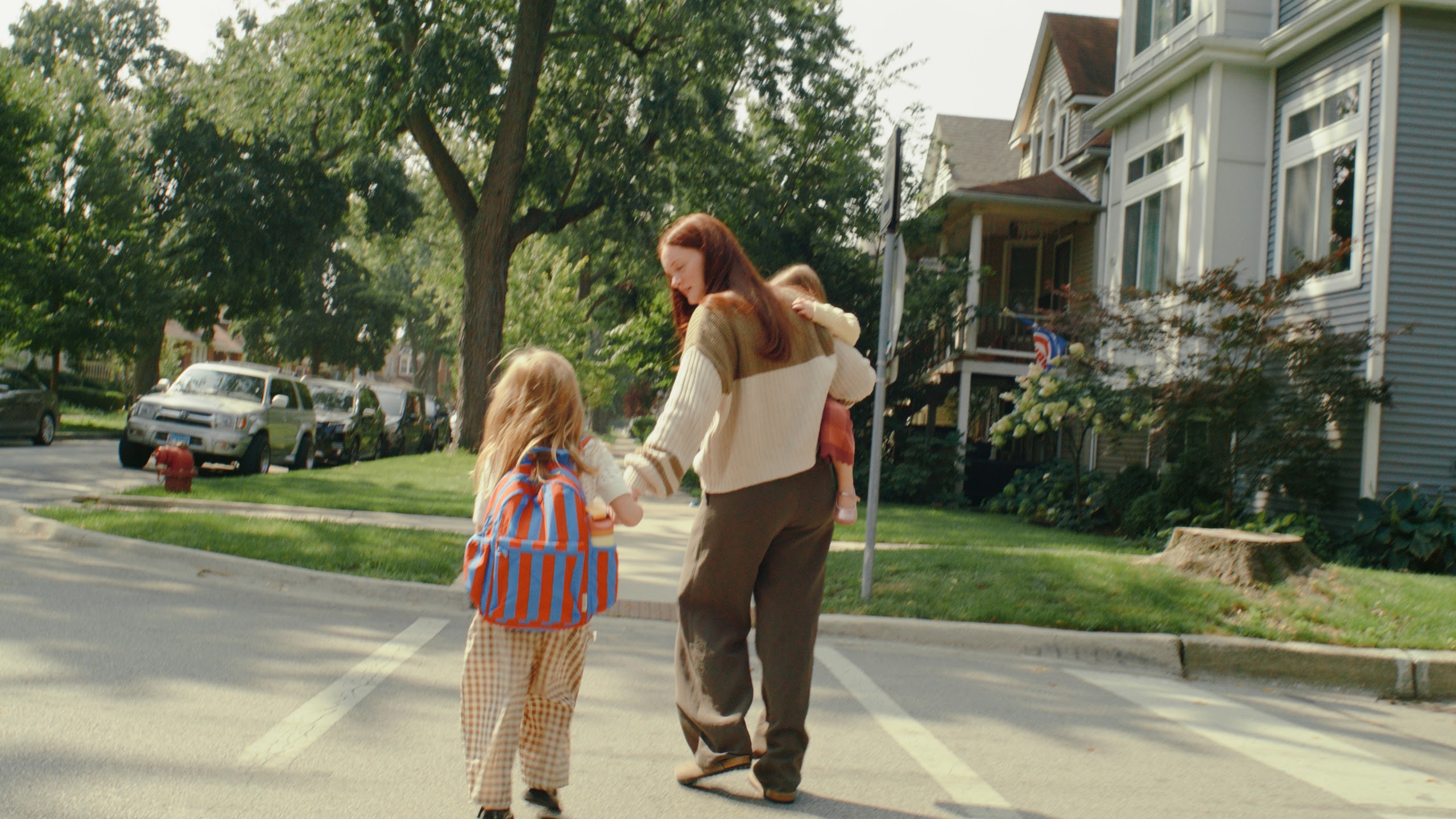 Mother and daughter walking a quiet neighborhood street