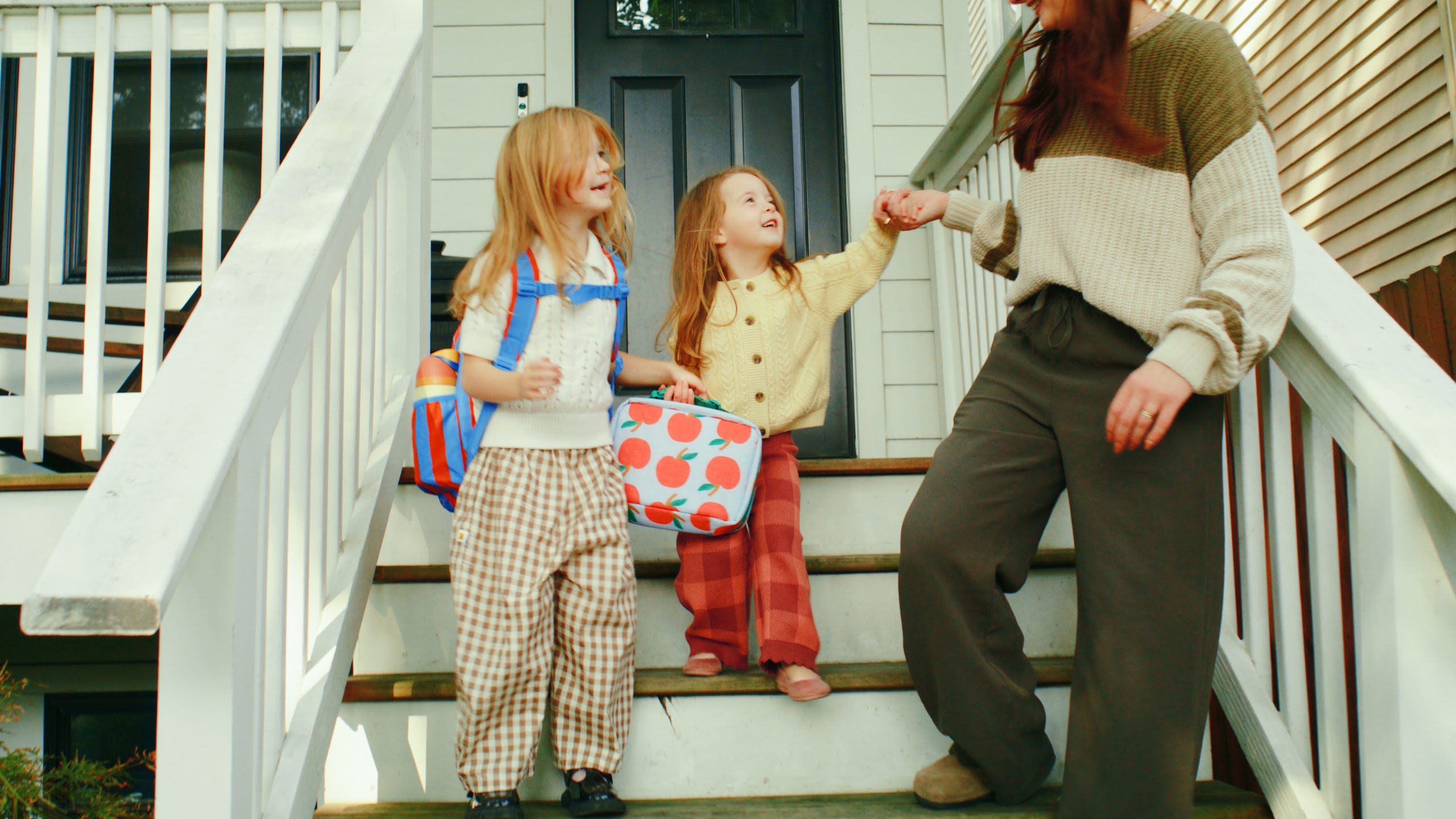 Family leaving the porch down the white front steps