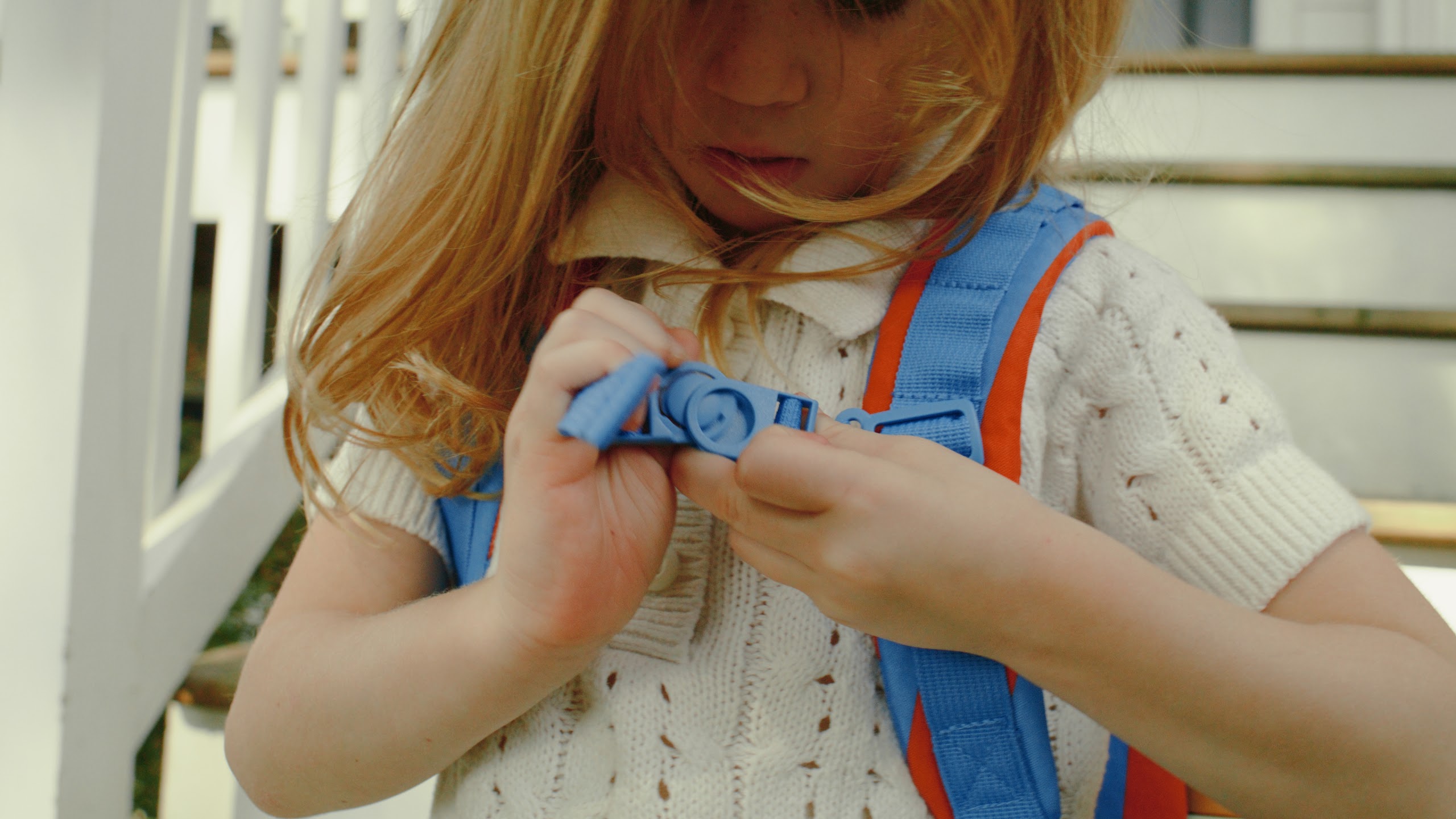 Girl adjusting the straps of her STORQ backpack