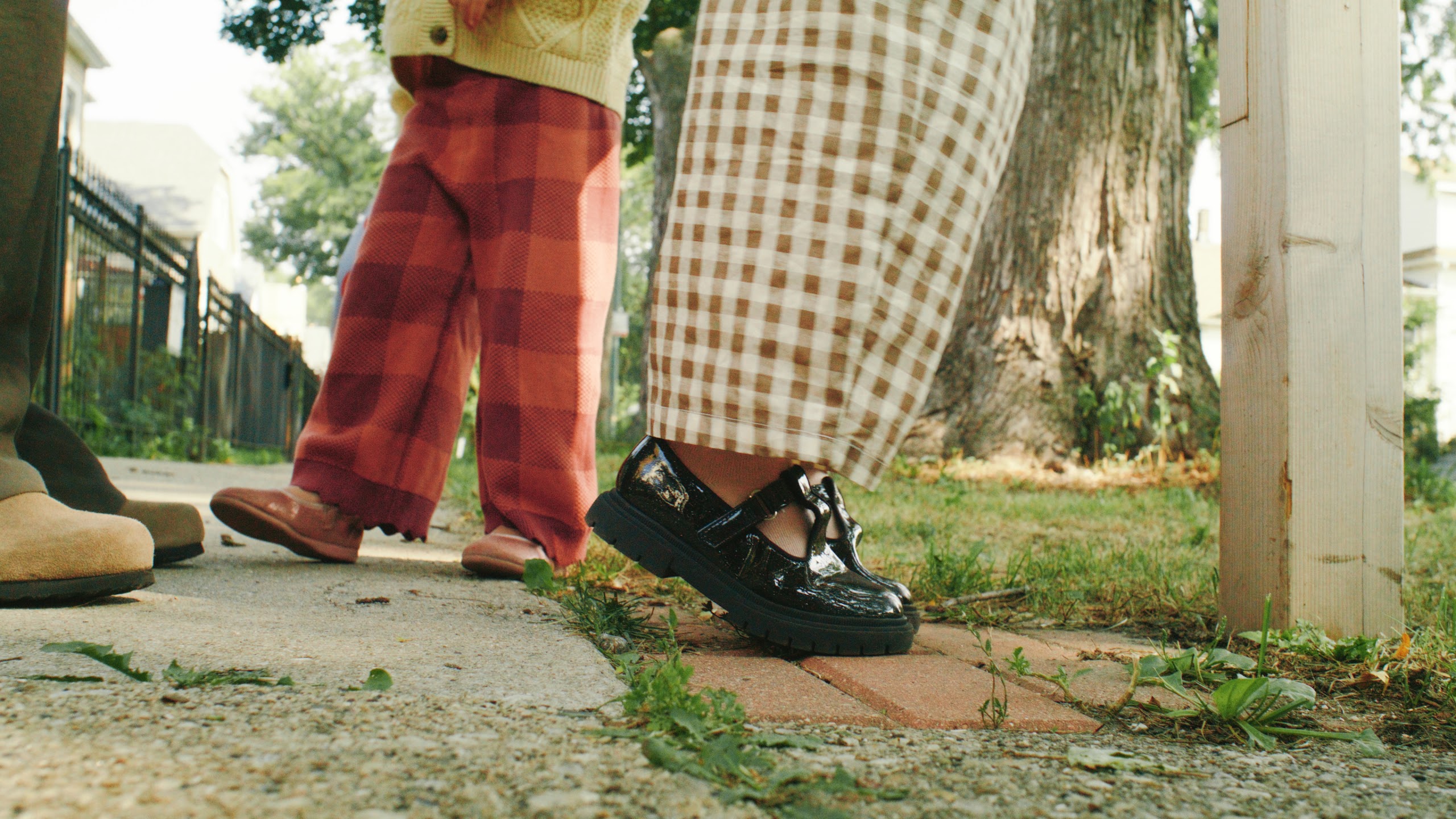 Plaid pants and school shoes on the sidewalk