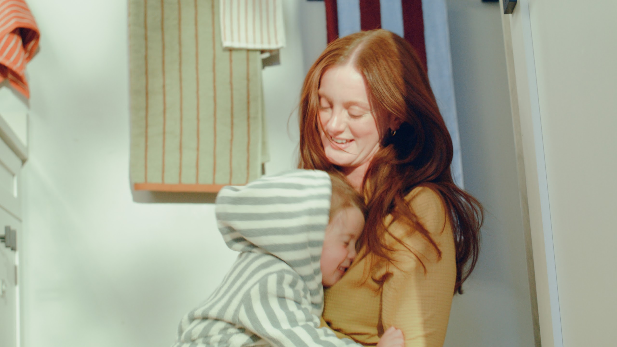 Mother smiling at her daughter by the front door