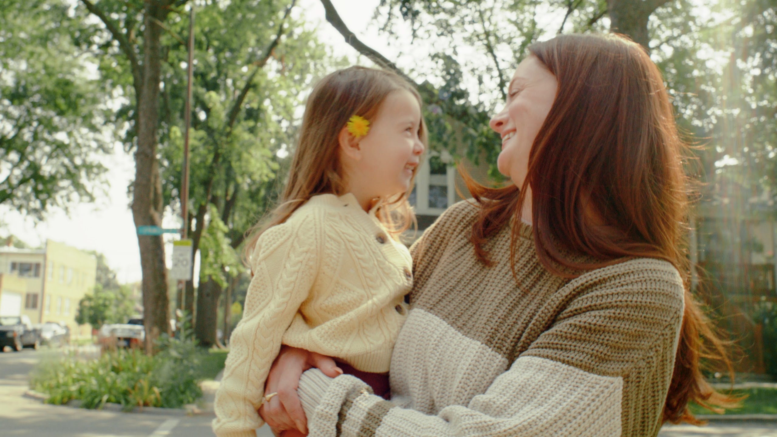 Mother hugging her daughter in the yard
