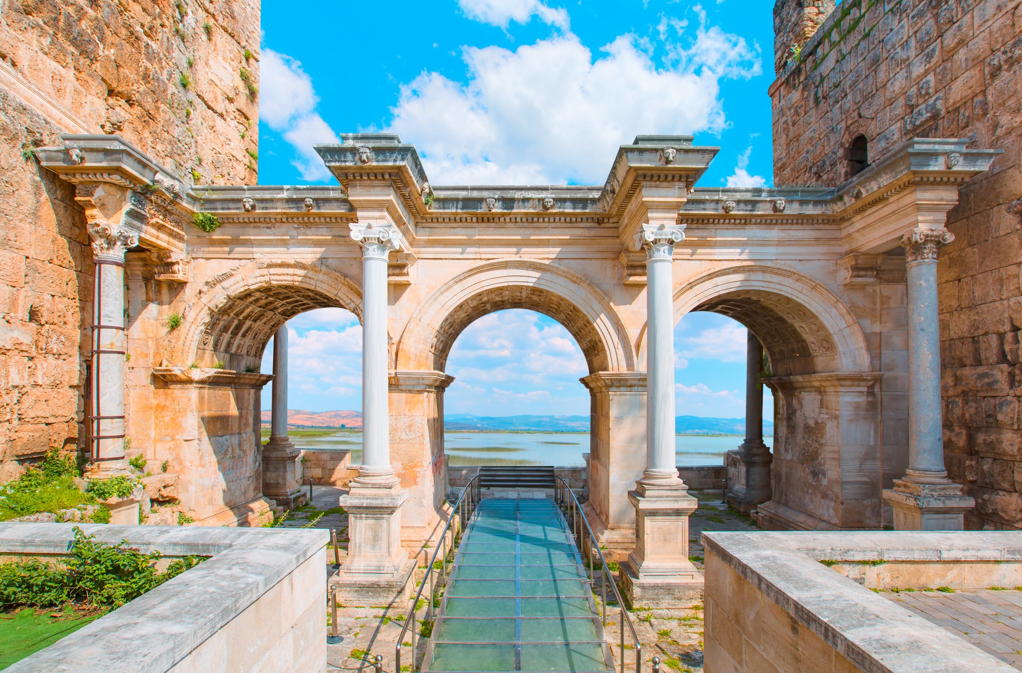 A scenic view of Kaleici and Hadrian’s Gate columns overlooking the sea.
